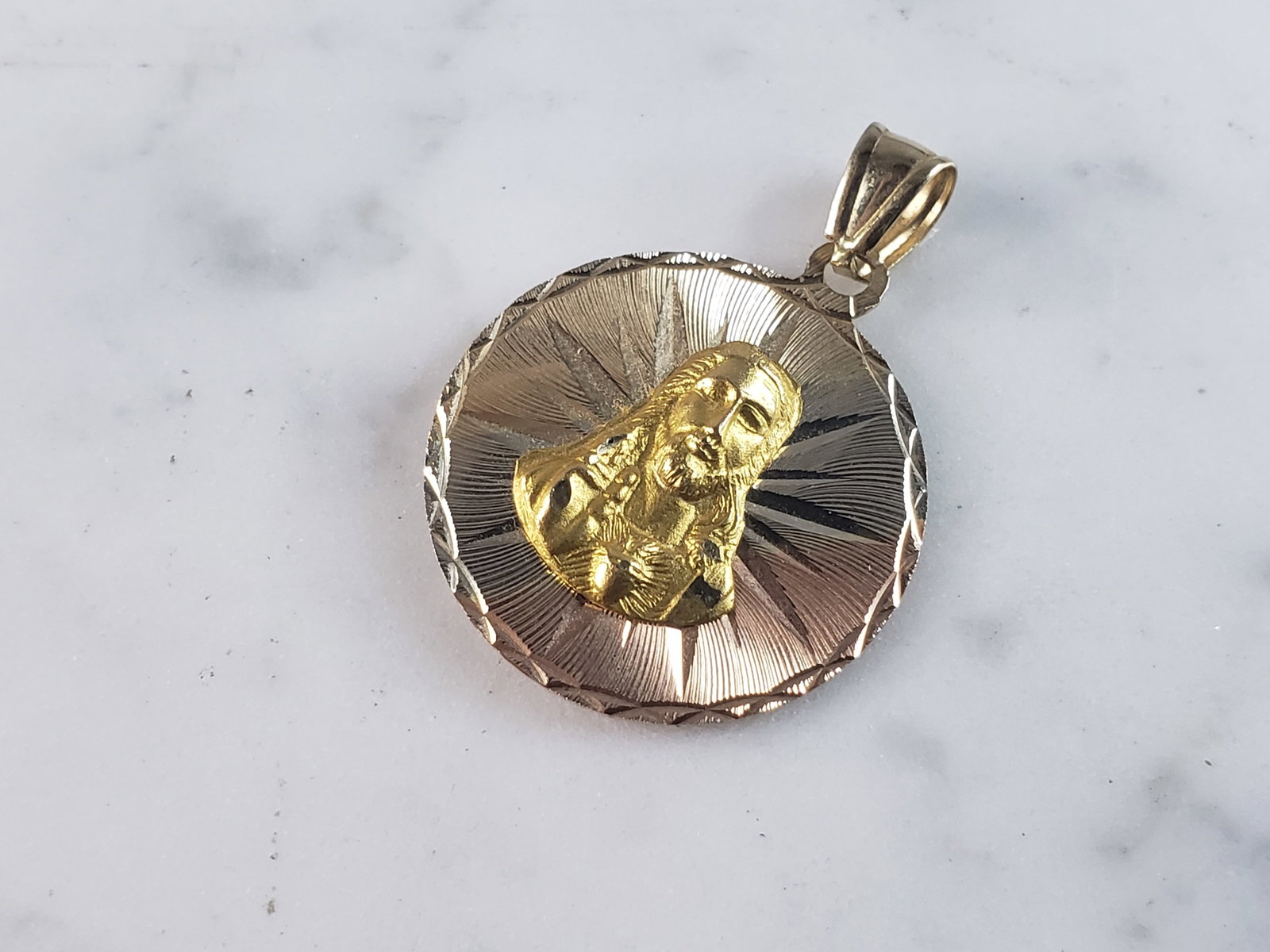 Vintage Estate 14K Mixed Gold Religious Pendant: A 14K MIXED GOLD RELIGIOUS PENDANT THAT WEIGHS 4.2g. THE PENDANT MEASURES 1 1/4" LONG BY 1" WIDE. PENDANT IS MARKED ON THE BALE. MAKES A GREAT GIFT FOR THAT SPECIAL SOMEONE.