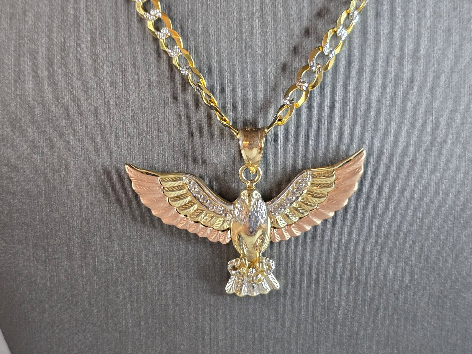 Vintage Estate 14K Tri Colored Gold Eagle Pendant Necklace: A VINTAGE ESTATE 14K TRI GOLD EAGLE PENDANT WITH NECKLACE. THE NECKLACE AND PENDANT WEIGHS 20.7g. THE NECKLACE MEASURES 22 1/8" LONG BY 3/16" WIDE. THE PENDANT MEASURES 1 1/4" LONG BY 1 3/4" WIDE. PEN