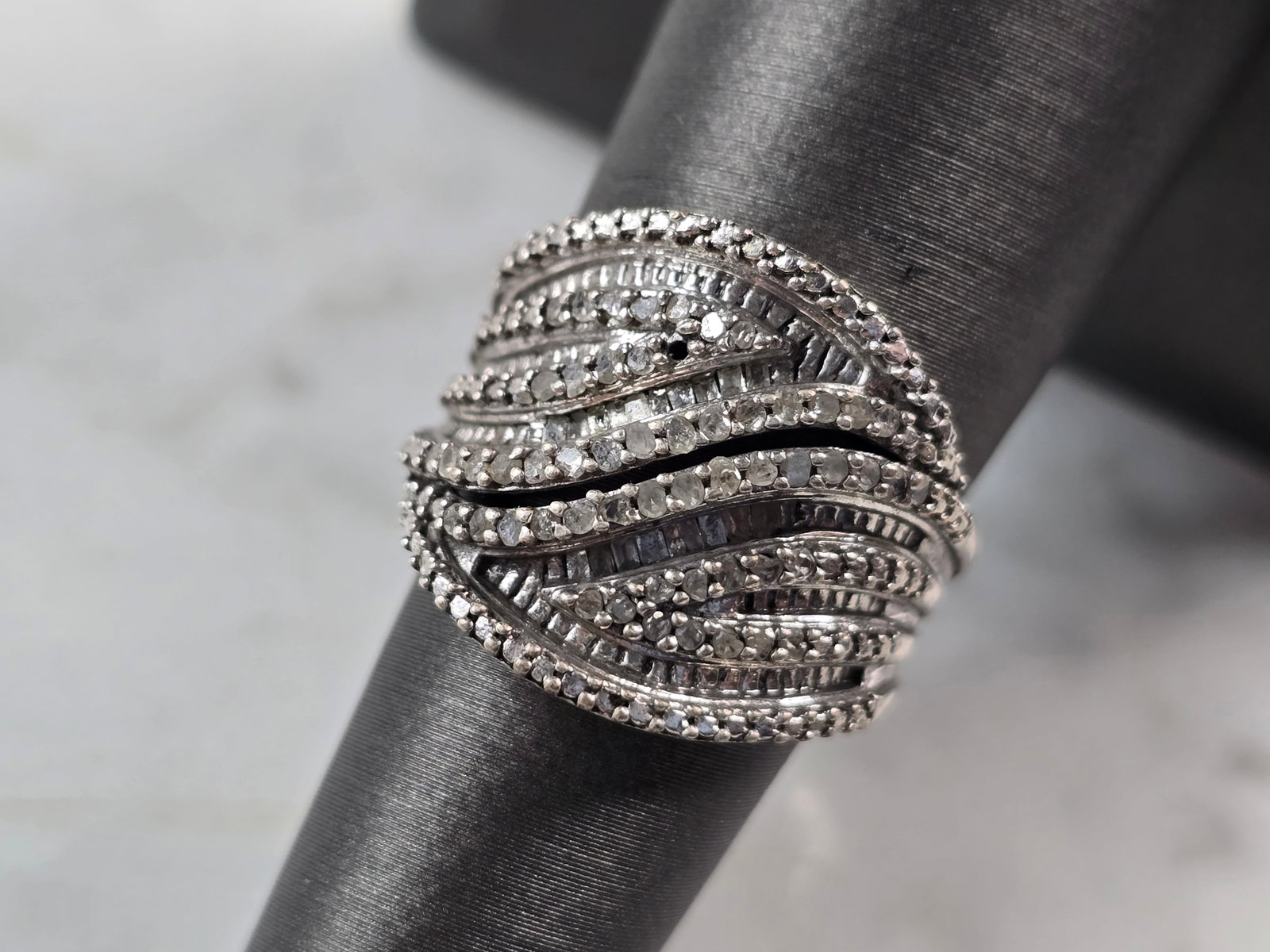 Womens Vintage Estate Sterling Silver Modernist Diamond Ring: A WOMENS VINTAGE ESTATE STERLING SILVER DIAMOND RING. THE RING WEIGHS 6.8g, AND IS A SIZE 6.75. THERE ARE ABOUT 50 TINY DIAMONDS IN THIS RING. RING IS ABOUT 5/8" WIDE. THERE IS ONE TINY DIAMOND MISSIN