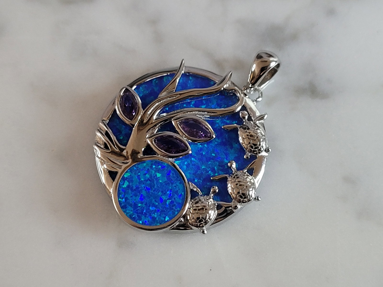 Womens Sterling Silver Blue Opal Baby Turtles Pendant: A WOMENS ESTATE STERLING SILVER BLUE OPAL BABY TURTLES PENDANT. NOT SURE IF STONES ARE REAL OR MAN MADE. THE PENDANT WEIGHS 5.8g AND MEASURES 1 1/8" LONG BY 1" WIDE. MAKES A GREAT GIFT FOR THAT SOMEON