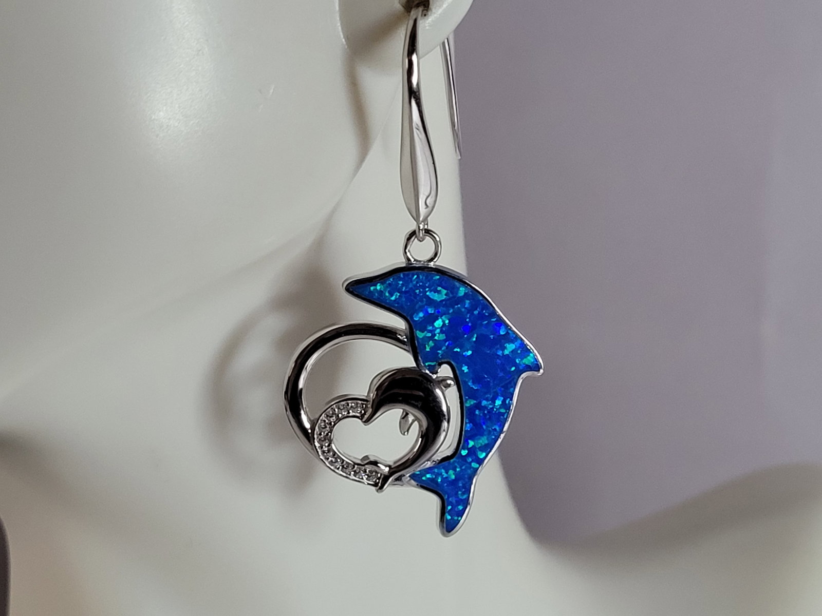 Womens Estate Sterling Silver Modernist Opal Dolphin Earrings: WOMENS ESTATE STERLING SILVER MODERNIST OPAL COLORED DOLPHIN EARRINGS THAT WEIGHS 8.6g AND MEASURES 1 3/4" LONG BY 7/8" WIDE. NOT SURE IF STONES ARE REAL OR MAN MADE. ANY OTHER QUESTIONS, PLEASE DO NO