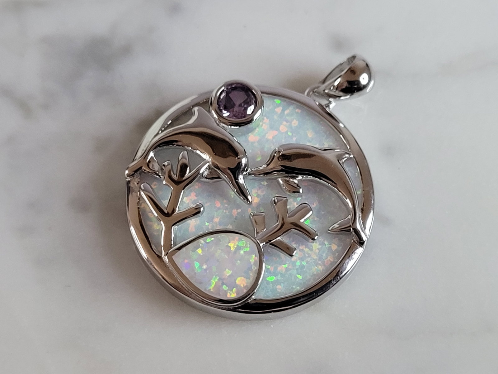 Womens Sterling Silver Opal Dolphin Pendant: A WOMENS STERLING SILVER OPAL DOLPHIN PENDANT. NOT SURE IF STONES ARE REAL OR MAN MADE. THE PENDANT WEIGHS 5.3g AND MEASURES 1 1/8" LONG BY 1" WIDE. MAKES A GREAT GIFT FOR THAT SOMEONE SPECIAL. ANY QU