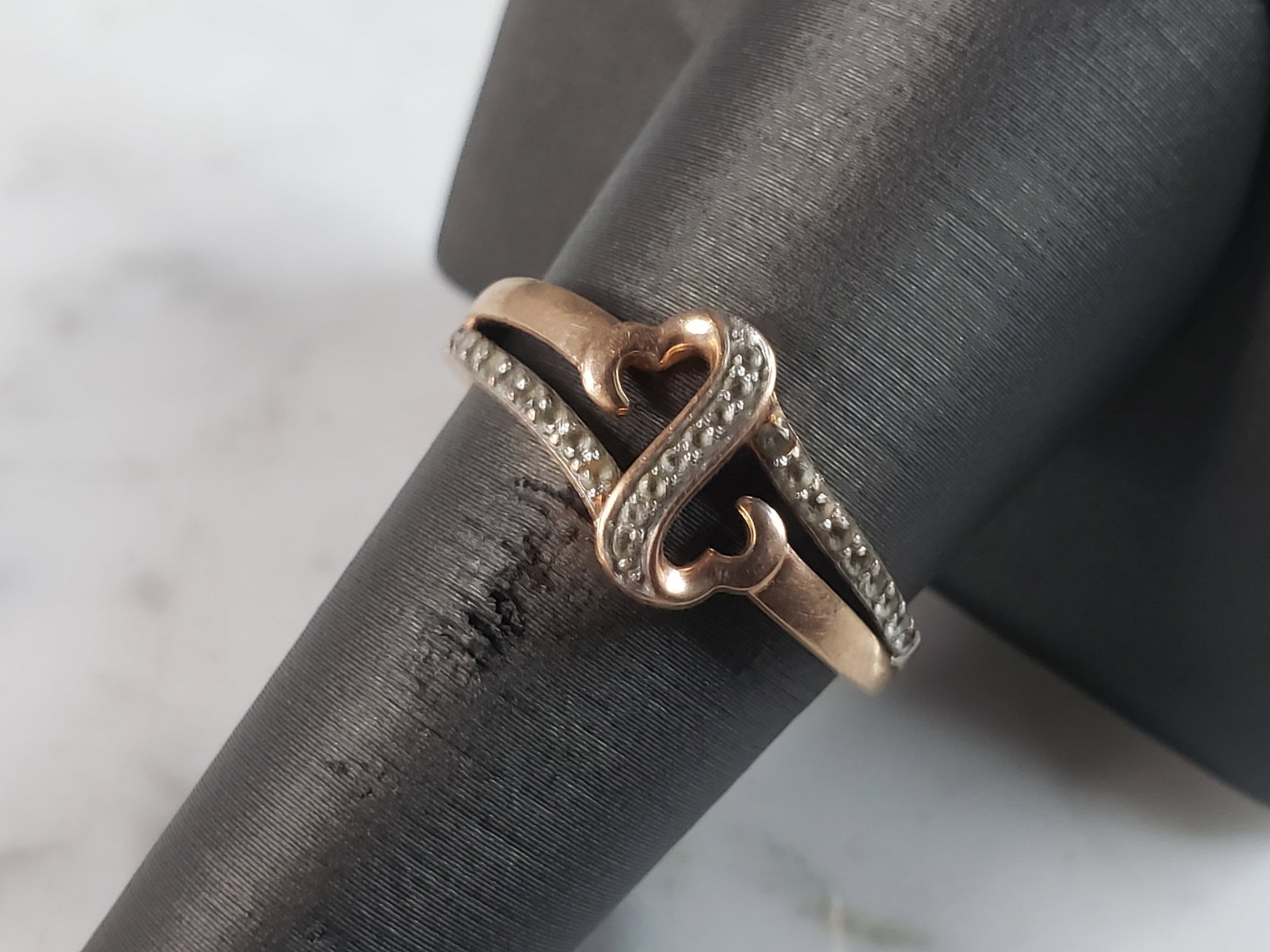 Womens Vintage Estate 10K Rose Gold Open Heart Diamond Ring: A WOMENS VINTAGE ESTATE 10K ROSE GOLD OPEN HEART DIAMOND RING. THERE ARE 24 TINY DIAMONDS. THE RING WEIGHS 2.9g, AND IS A SIZE 8.5. RING IS STAMPED "10K". THERE ARE TWON TINY DIAMONDS MISSING ON EACH 