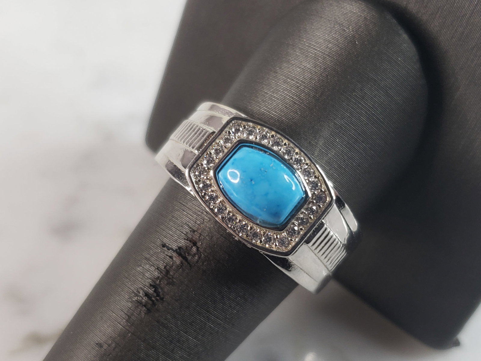 Mens Estate Sterling Silver Turquoise Ring: A MENS ESTATE STERLING SILVER TURQUOISE RING. THE RING IS A SIZE 10.0, AND WEIGHS 12.0g. NOT SURE IF THE STONE IS REAL OR MAN MADE. WIDTH OF THE RING IS 1/2". THE RING MAKES A BEAUTIFUL, IMPRESSIVE GI