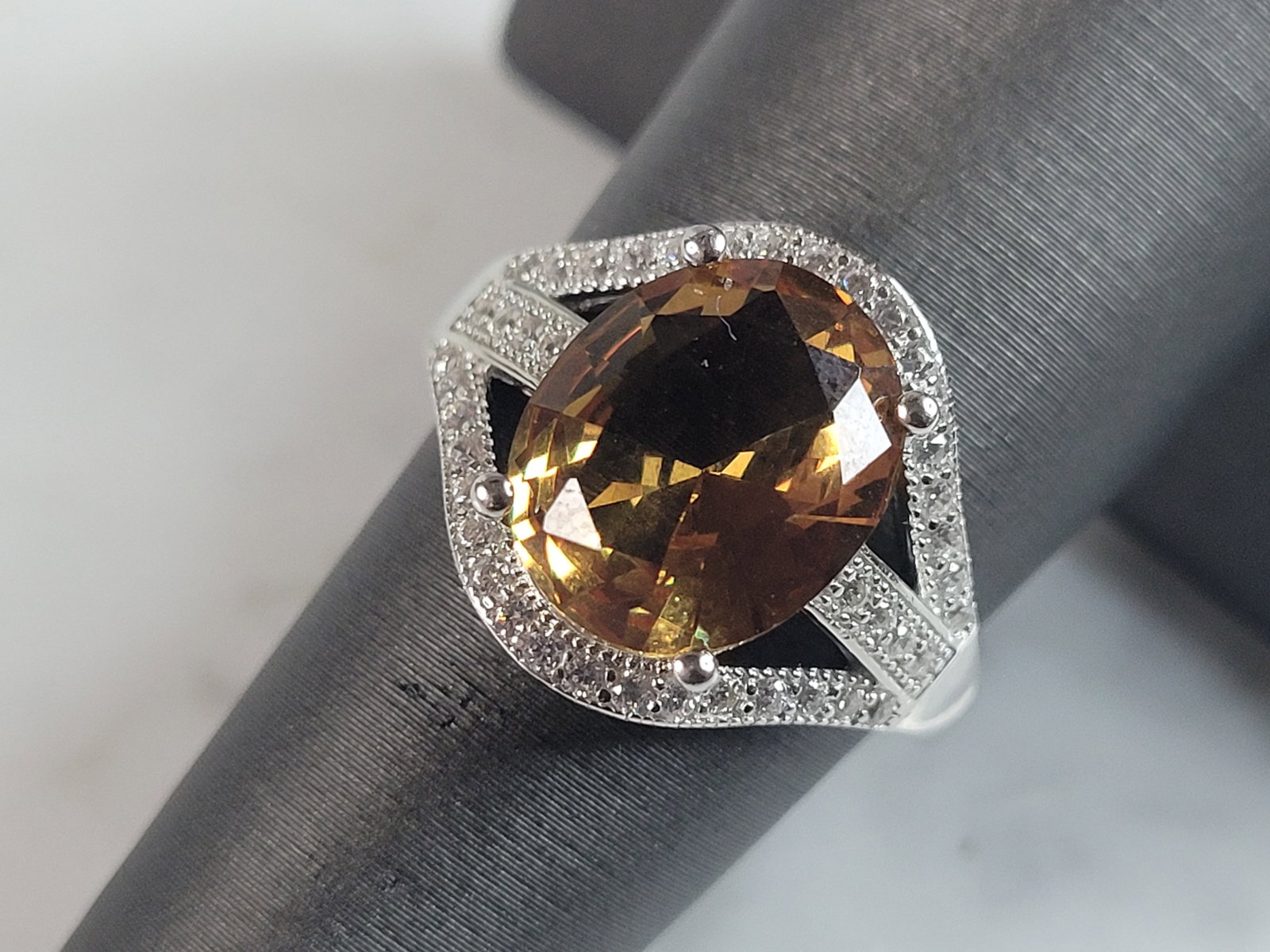 Womens Estate Sterling Silver Citrine Ring: A WOMENS ESTATE STERLING SILVER MODERNIST RING. THE RING IS A SIZE 6.25 AND WEIGHS 4.2g. STONE IS A CITRINE COLORED GLASS. WIDTH OF THE RING IS ABOUT 5/8". THE RING MAKES A BEAUTIFUL, IMPRESSIVE GIFT 
