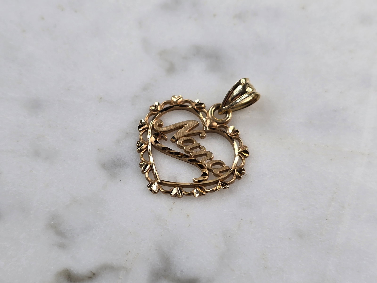 Womens Vintage 14k Gold Michael Anthony Nana Love Heart Pendant: A WOMENS VINTAGE ESTATE 14K GOLD "NANA" LOVE HEART PENDANT MADE BY MICHAEL ANTHONY. THE TOTAL WEIGHT IS 0.9g. THE PENDANT MEASURES 3/4" LONG BY 5/8" WIDE. PENDANT IS MARKED ON THE BACK. MAKES A GREAT 