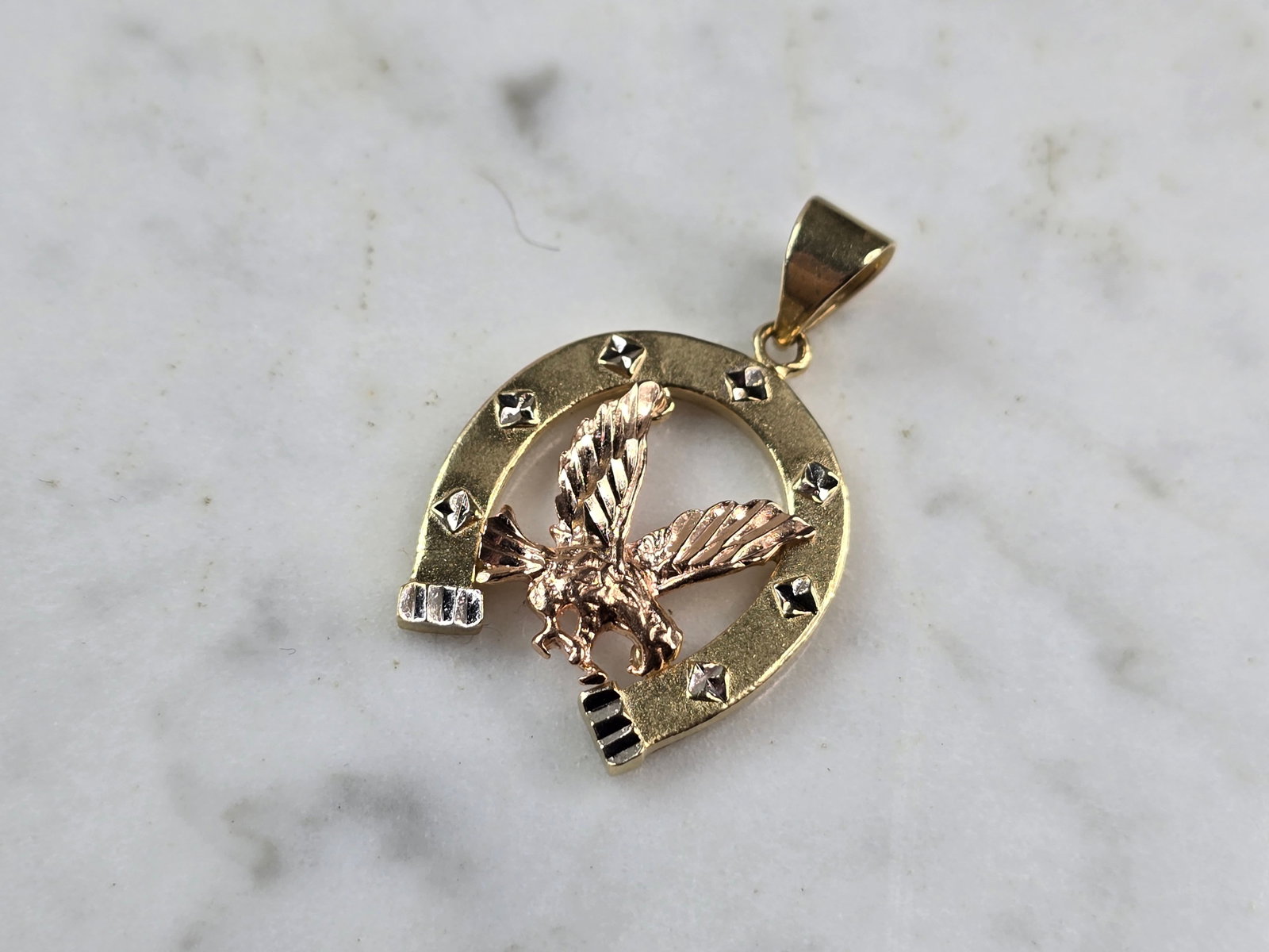 Womens Vintage Estate 14k Mixed Gold Horseshoe Eagle Pendant: A WOMENS VINTAGE ESTATE 14K MIXED GOLD HORSESHOE EAGLE PENDANT. THE PENDANT WEIGHS 3.8g, AND MEASURES 1 1/4" BY 3/4" WIDE. PENDANT IS MARKED ON THE BACK. MAKES A GREAT GIFT FOR THAT SPECIAL SOMEONE. A