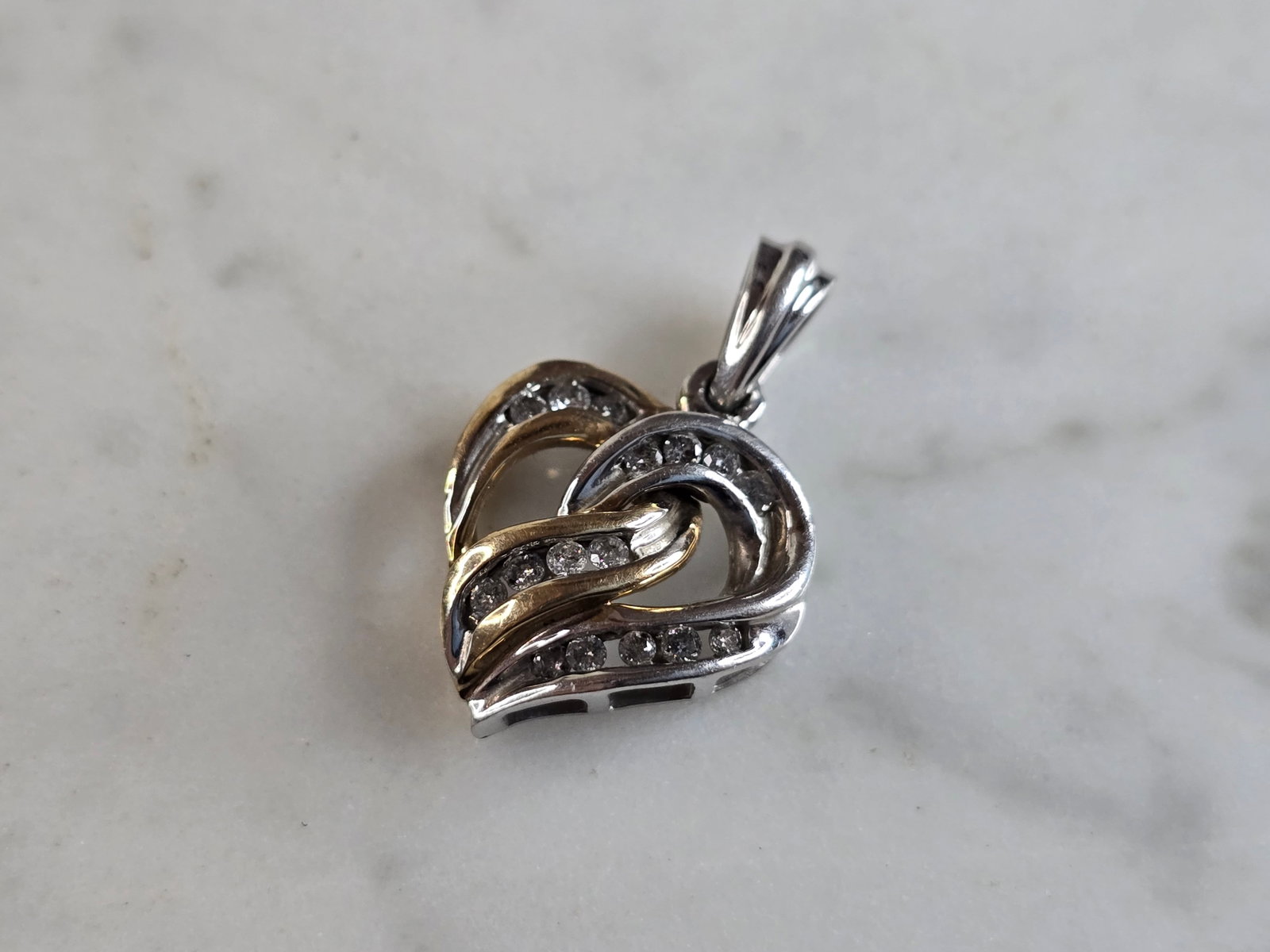 Womens Vintage Estate 10K Mixed Gold Heart Diamond Pendant: A WOMENS VINTAGE ESTATE 10K YELLOW & WHITE GOLD HEART PENDANT WITH DIAMONDS. PENDANT WEIGHS 3.1g, AND MEASURES 7/8" BY 1/2". THERE ARE ABOUT .32cts OF DIAMONDS IN THIS PENDANT. WOULD MAKE A LOVELY GIF