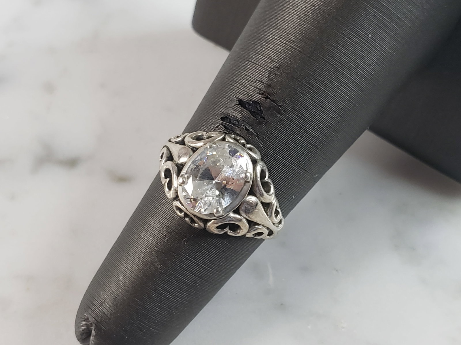 Womens Vintage Estate Sterling Silver CZ Heart Ring: A WOMENS VINTAGE ESTATE STERLING SILVER CZ RING. THE RING SIZE IS A 5.0, AND WEIGHS 2.5g. THE WIDTH OF THE RING IS 3/8". RING IS MARKED KBN, 925. THIS WOULD MAKE A NICE GIFT FOR THAT SOMEONE SPECIAL. 
