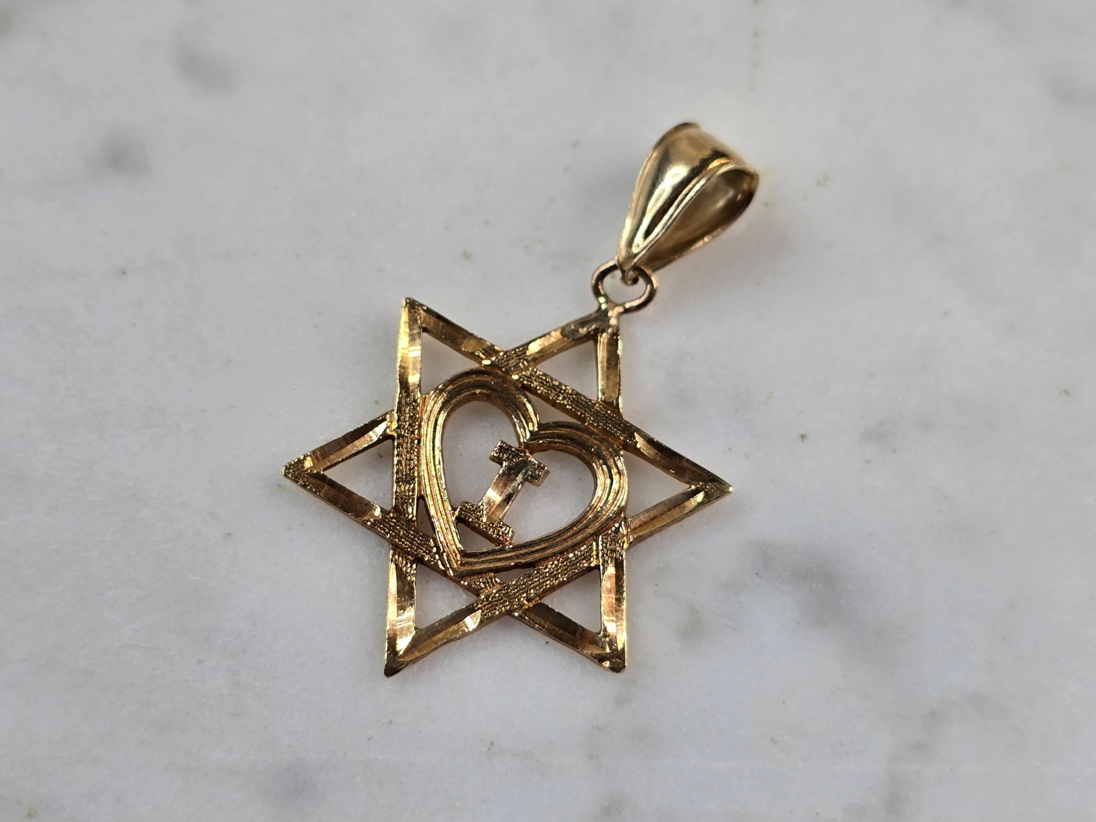 14K Gold Jewish Judaica Star of David Letter " I " Heart Pendant: A 14K YELLOW GOLD JUDAICA STAR OF DAVID HEART PENDANT WITH THE LETTER "I" IN THE MIDDLE. THE PENDANT WEIGHS 1.5g, AND MEASURES 1 1/4" LONG BY 3/4" WIDE. MAKES A GREAT GIFT FOR THAT SOMEONE SPECIAL. AN