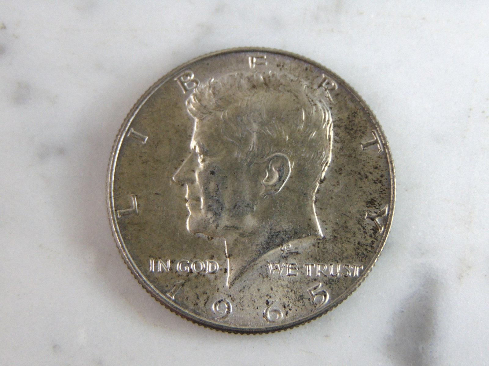 1965 Kennedy Half Dollar Coin: FOR SALE IS THIS 1965 KENNEDY HALF DOLLAR COIN. WE ARE NOT COIN EXPERTS WHEN IT COMES TO PROPER GRADING. PICTURES SHOULD BE CLEAR ENOUGH TO SEE ANY KIND OF BLEMISHES. BUYING AS IS. WOULD MAKE A GREAT 