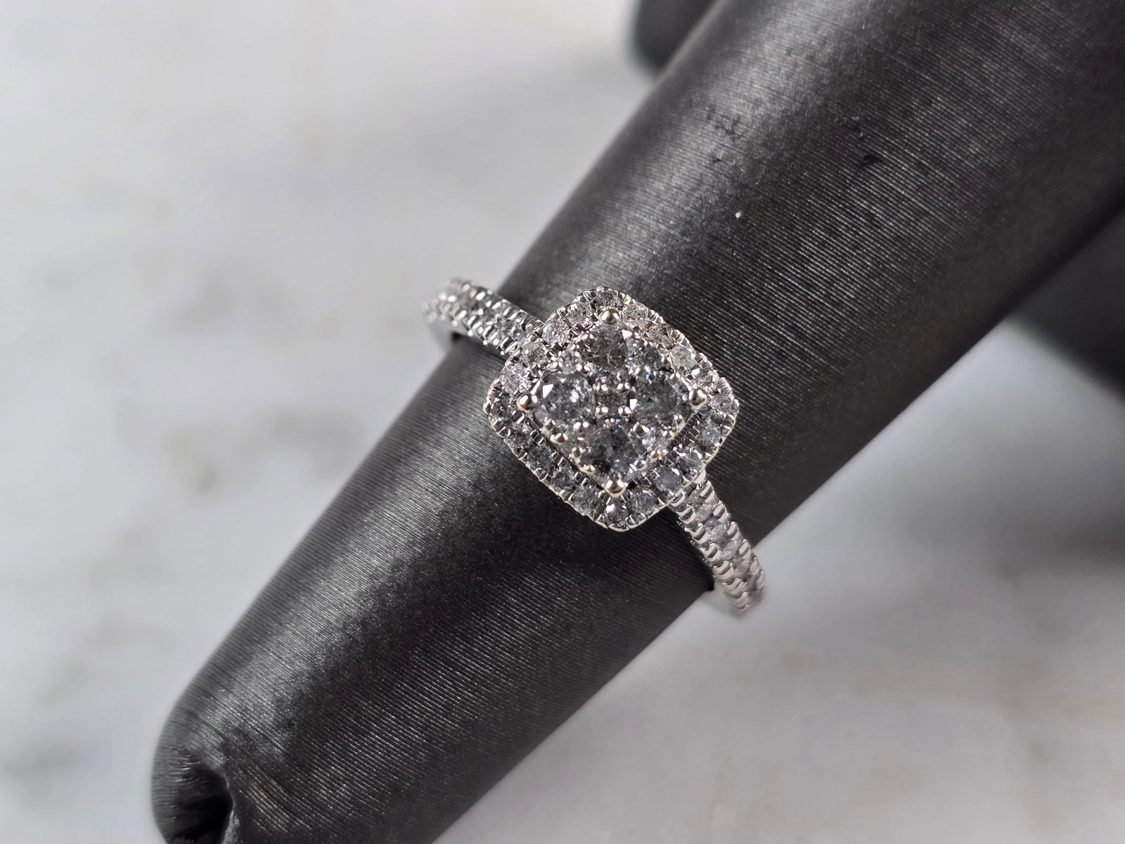 Womens Vintage Estate 10K White Gold Diamond Engagement Ring: A WOMENS VINTAGE ESTATE 10K WHITE GOLD DIAMOND ENGAGEMENT RING. THE TOTAL WEIGHT IS 2.3g. THE CENTER HAS ABOUT 0.12cts WITH 35 TINY ACCENT DIAMONDS. THE SIZE OF THE RING IS A 5.0, AND IS ABOUT 5/16" W