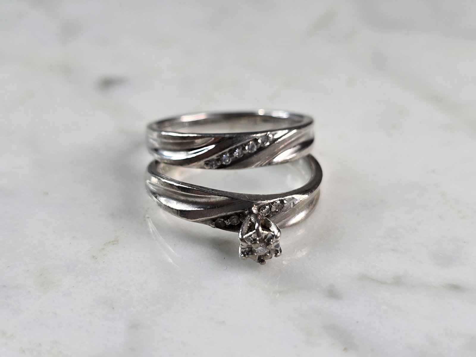Womens Vintage Estate Sterling Silver Modernist Diamond Ring Set: A WOMENS ESTATE STERLING SILVER MODERNIST DIAMOND RING SET. THE RING IS A SIZE 7.0 AND WEIGHS 5.5g TOGETHER. WIDTH OF THE RINGS MEASURES 3/8". THERE ARE 9 TINY DIAMONDS. THE RING MAKES A BEAUTIFUL GIF