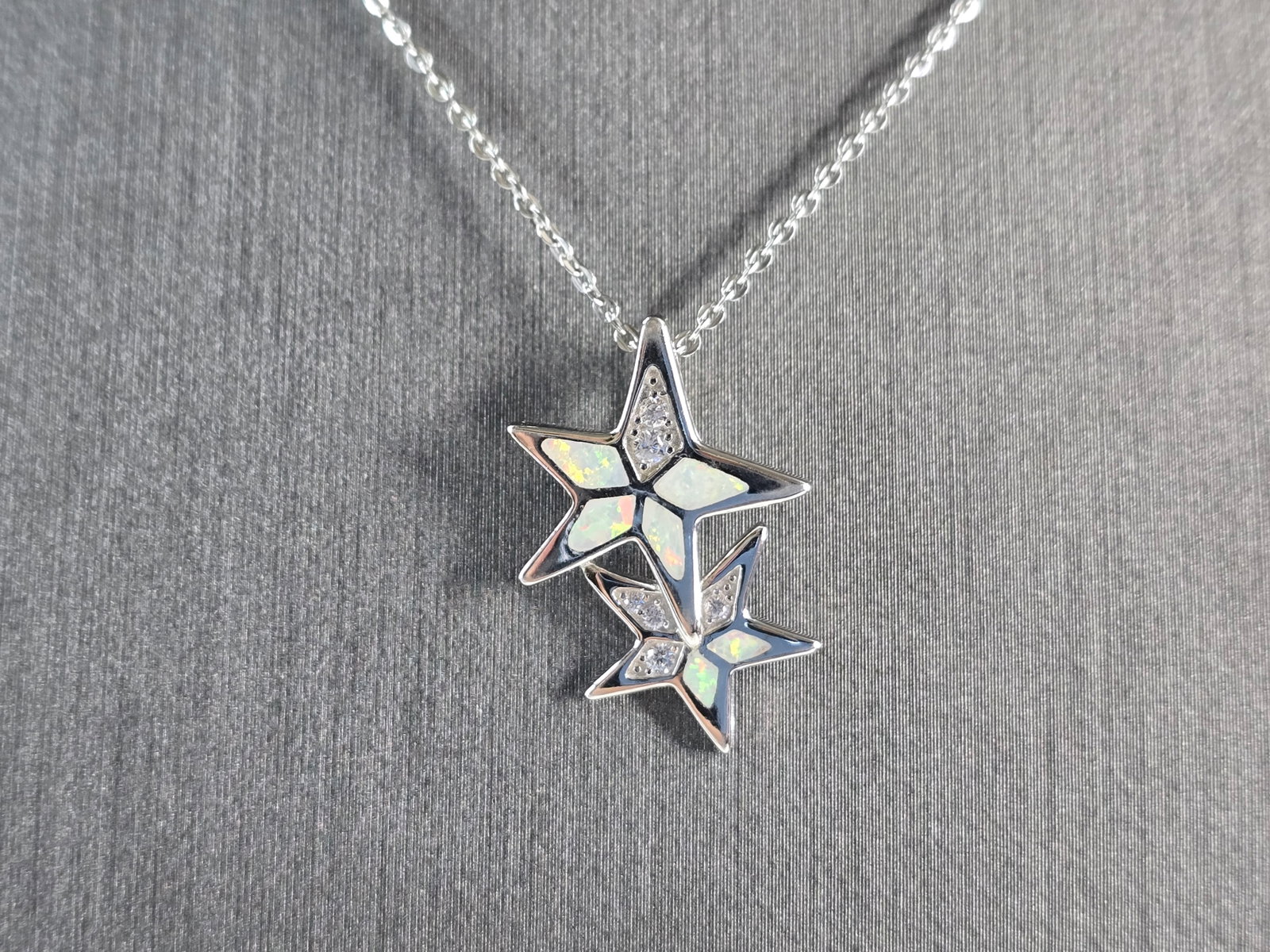 Womens Sterling Silver Opal Star Pendant Necklace: A WOMENS STERLING SILVER OPAL MODERNIST STAR PENDANT. THE PENDANT WITH NECKLACE WEIGHS 3.8g. PENDANT MEASURES 7/8" LONG BY 5/8" WIDE, AND THE NECKLACE MEASURES 18" LONG, ADJUSTABLE TO 16". NOT SURE IF