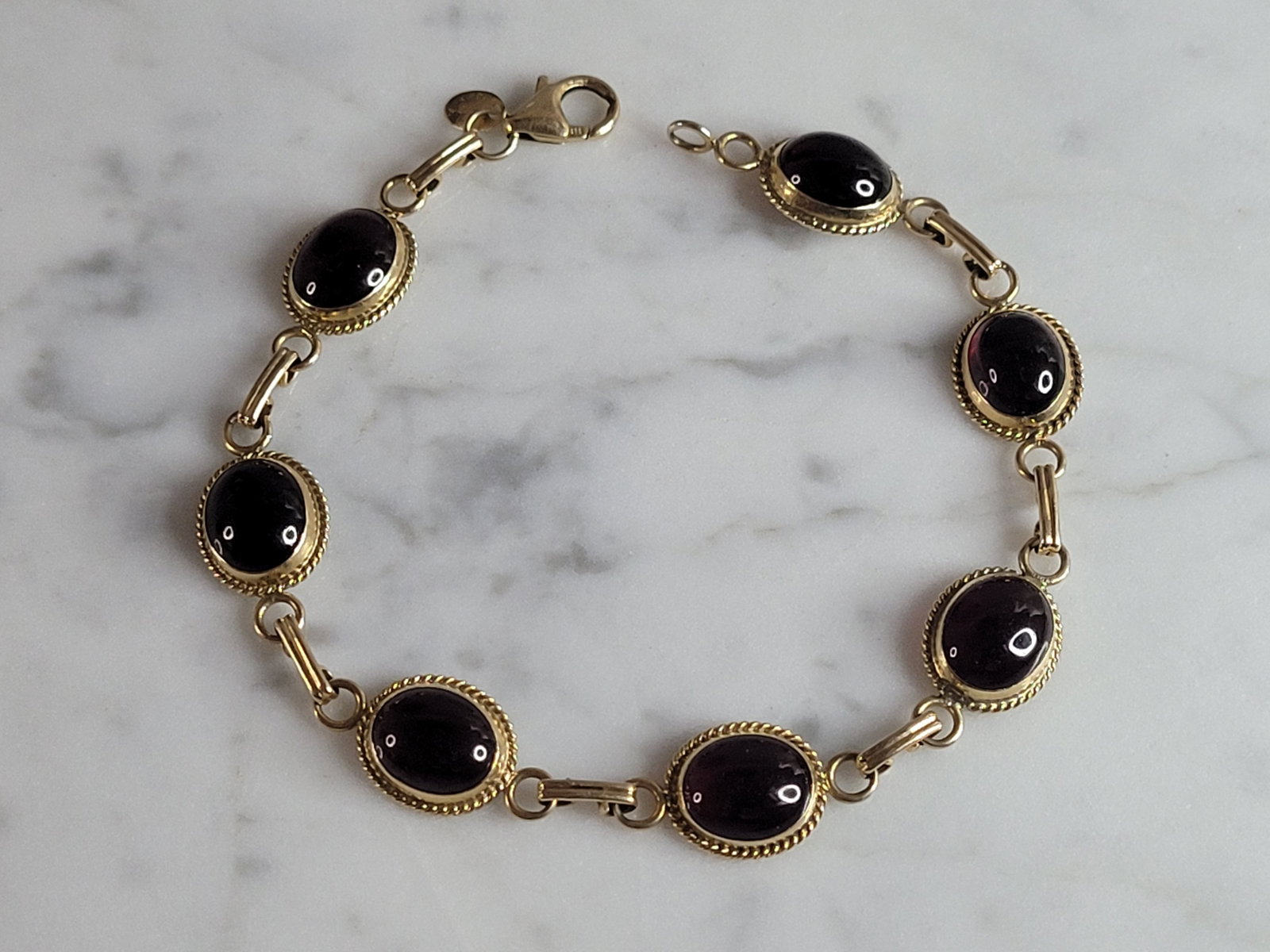 Womens Vintage Estate 14k Gold CARLA Amethyst Bracelet: A WOMENS VINTAGE ESTATE 14K GOLD AMETHYST BRACELET. BRACELET IS 7 3/4" LONG BY 3/8" WIDE, AND WEIGHS 9.8g. BRACELET IS MARKED "CARLA, 14KT". STONES ARE A LITTLE DECEIVING DEPENDING ON THE LIGHT. LOOKS
