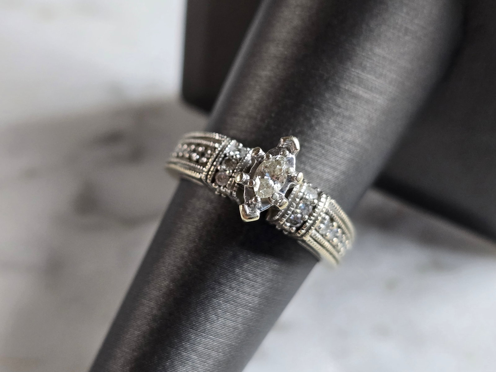 Womens Vintage Estate 14K White Gold Modernist Diamond Ring: A WOMENS VINTAGE ESTATE 14K WHITE GOLD DIAMOND RING. THE RING IS A SIZE 7.25 AND WEIGHS 5.3g. THERE ARE ABOUT .28cts OF DIAMONDS IN THE RING. THE LENGTH OF THE RING IS 3/8". RING IS MARKED 14K. ANY QU