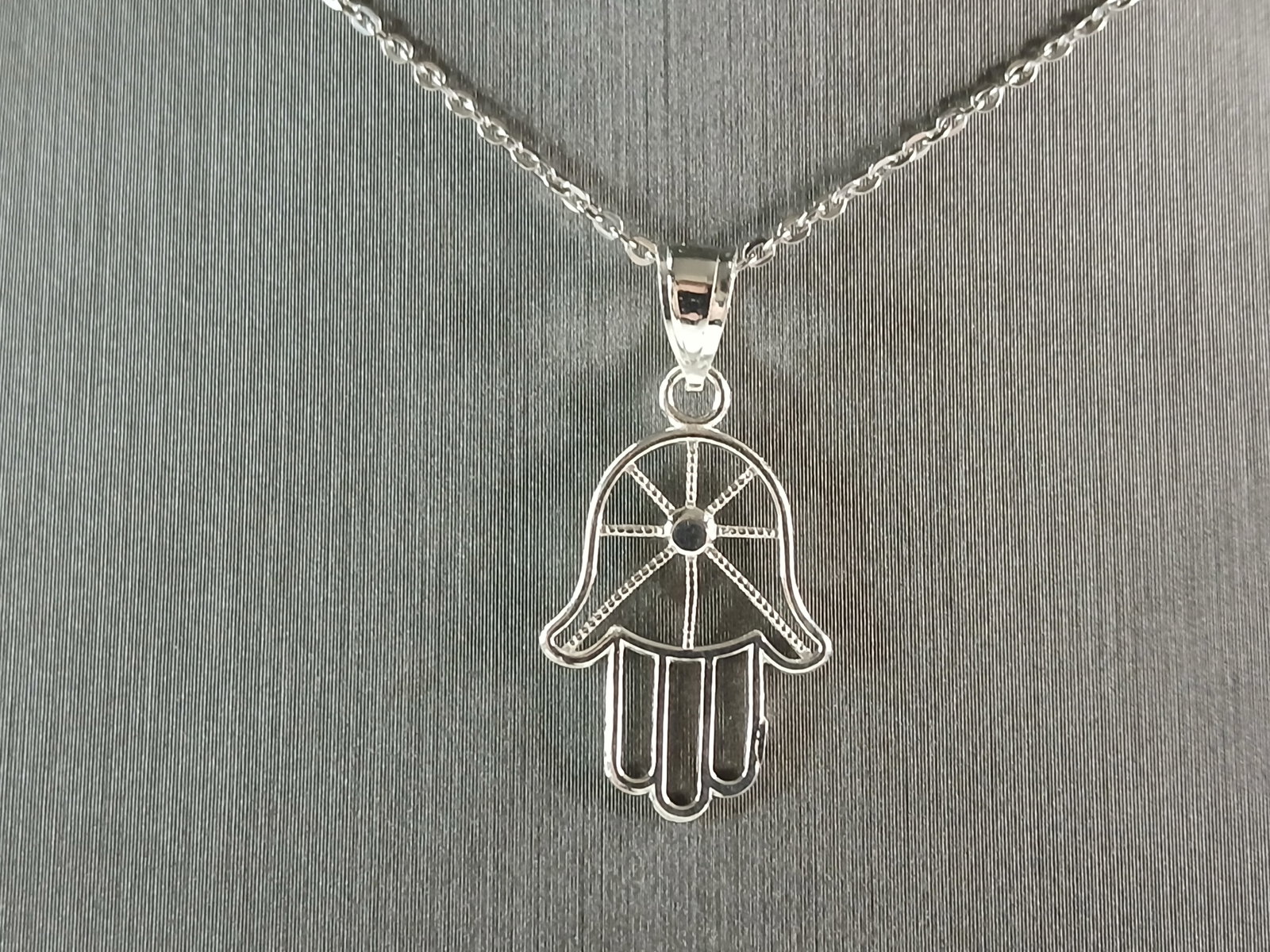 Womens Sterling Silver Hamsa Hand Pendant Necklace: A WOMENS STERLING SILVER HAMSA HAND PENDANT WITH NECKLACE. THE PENDANT WITH NECKLACE WEIGHS 2.5g. THE PENDANT MEASURES 1" BY 1/2", AND THE NECKLACE MEASURES 18" LONG. MAKES A GREAT GIFT FOR THAT SPECI