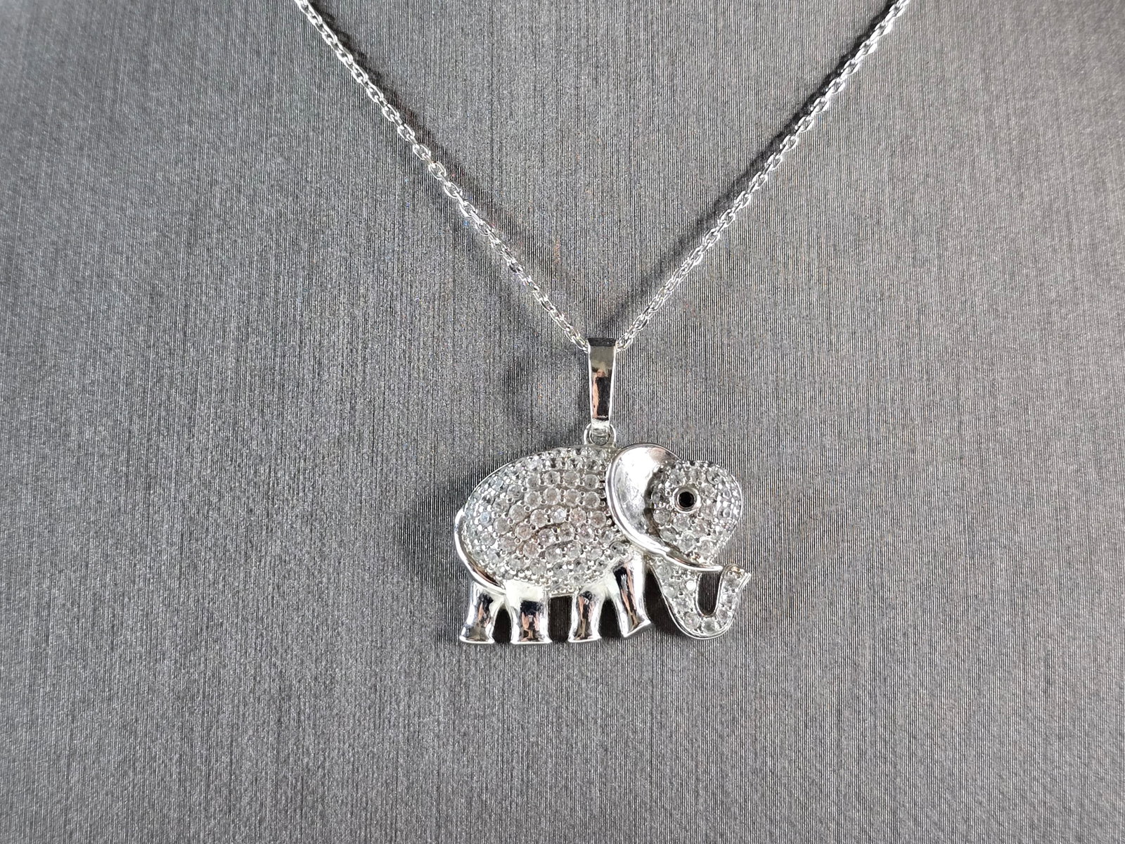 Womens Vintage Estate Sterling Silver CZ Elephant Pendant Necklace: A WOMENS VINTAGE ESTATE STERLING SILVER CZ ELEPHANT PENDANT WITH NECKLACE. THE PENDANT AND NECKLACE WEIGH 6.5g. THE NECKLACE MEASURES 18", AND IS ADJUSTABLE TO 16". THE PENDANT MEASURES 1" LONG BY 1" 