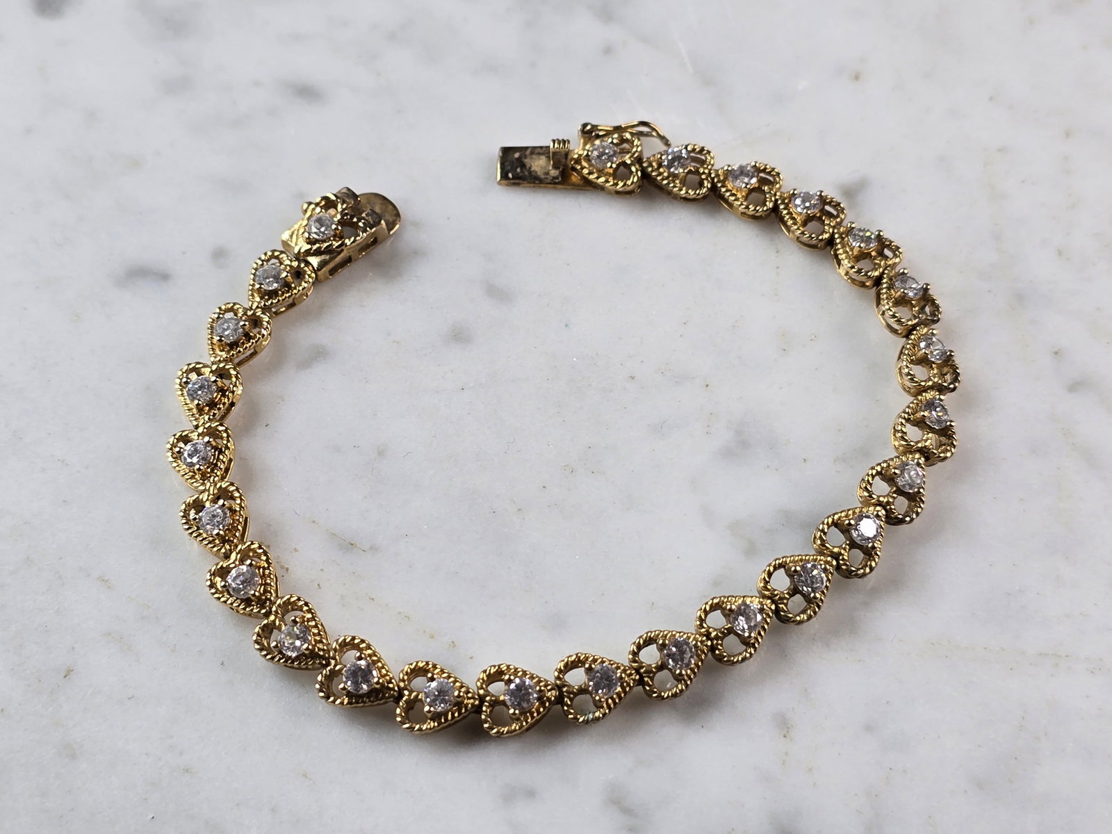 Womens Vintage Estate Sterling Silver Gold Tone CZ Heart Bracelet: A WOMENS VINTAGE ESTATE STERLING SILVER GOLD TONE CZ HEART BRACELET. BRACELET MEASURES 7 1/2" LONG BY 1/4" WIDE, AND WEIGHS 13.6g. THIS WOULD MAKE A LOVELY GIFT FOR THAT SOMEONE SPECIAL. ANY QUESTIONS