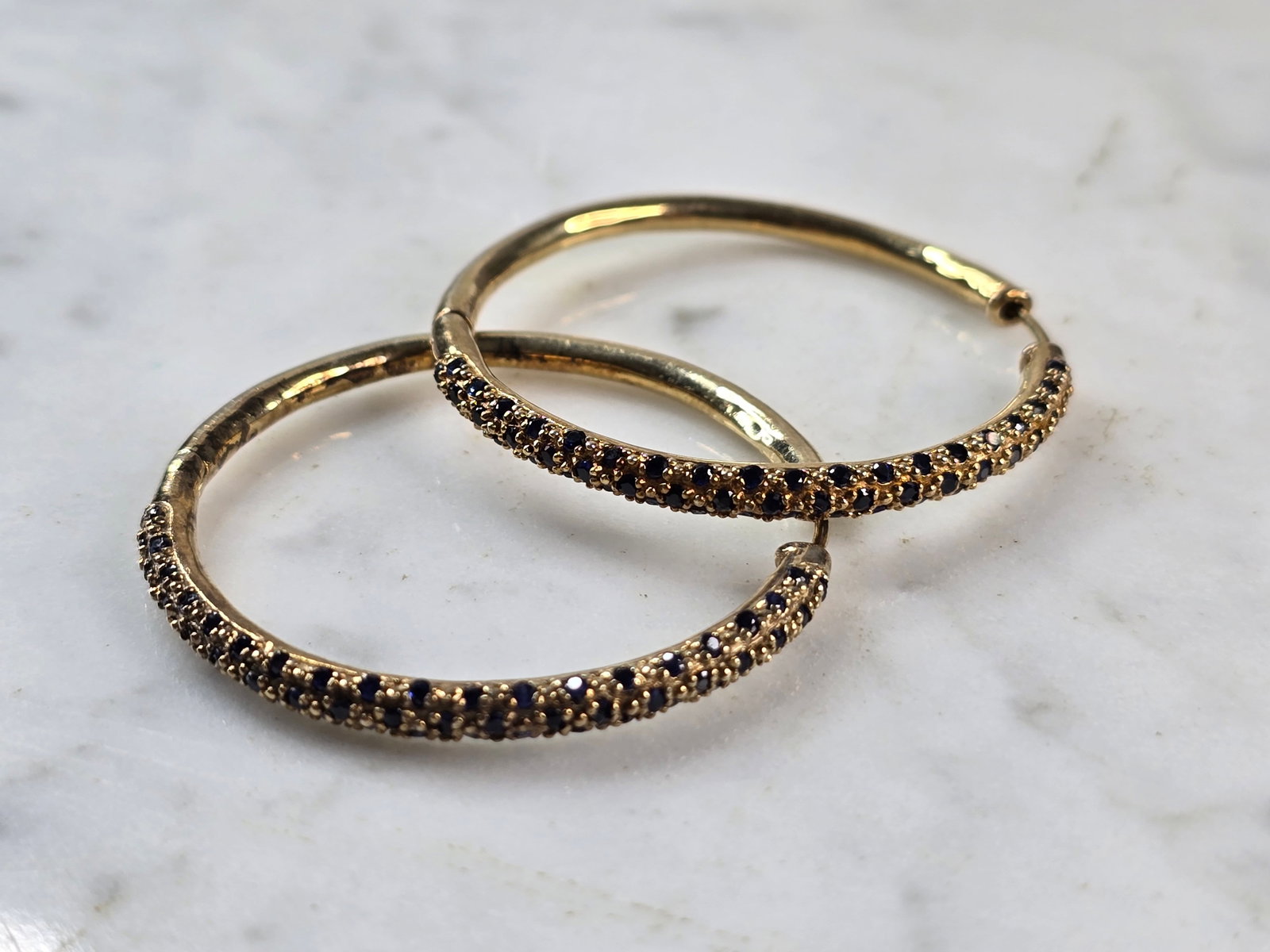 Womens Estate Sterling Silver Gold Tone Sapphire Hoop Earrings: A PAIR OF WOMENS STERLING SILVER GOLD TONE SAPPHIRE HOOP EARRINGS. EARRINGS WEIGH 10.3g AND MEASURE 1 1/2" BY 1/8". NOT SURE IF STONES ARE NATURAL OR MAN MADE. ANY QUESTIONS, PLEASE DO NOT HESITATE TO