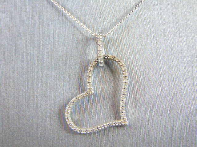 Vintage Sterling Silver Necklace Diamond Heart Pendant: FOR SALE IS THIS LOVELY VINTAGE WOMEN'S .925 STERLING SILVER NECKLACE WITH HEART PENDANT WITH DIAMONDS. THE TOTAL WEIGHT IS 3.3g. THE NECKLACE MEASURES 20" FROM THE CLASP AND THE HEART MEASURES 1 " AC