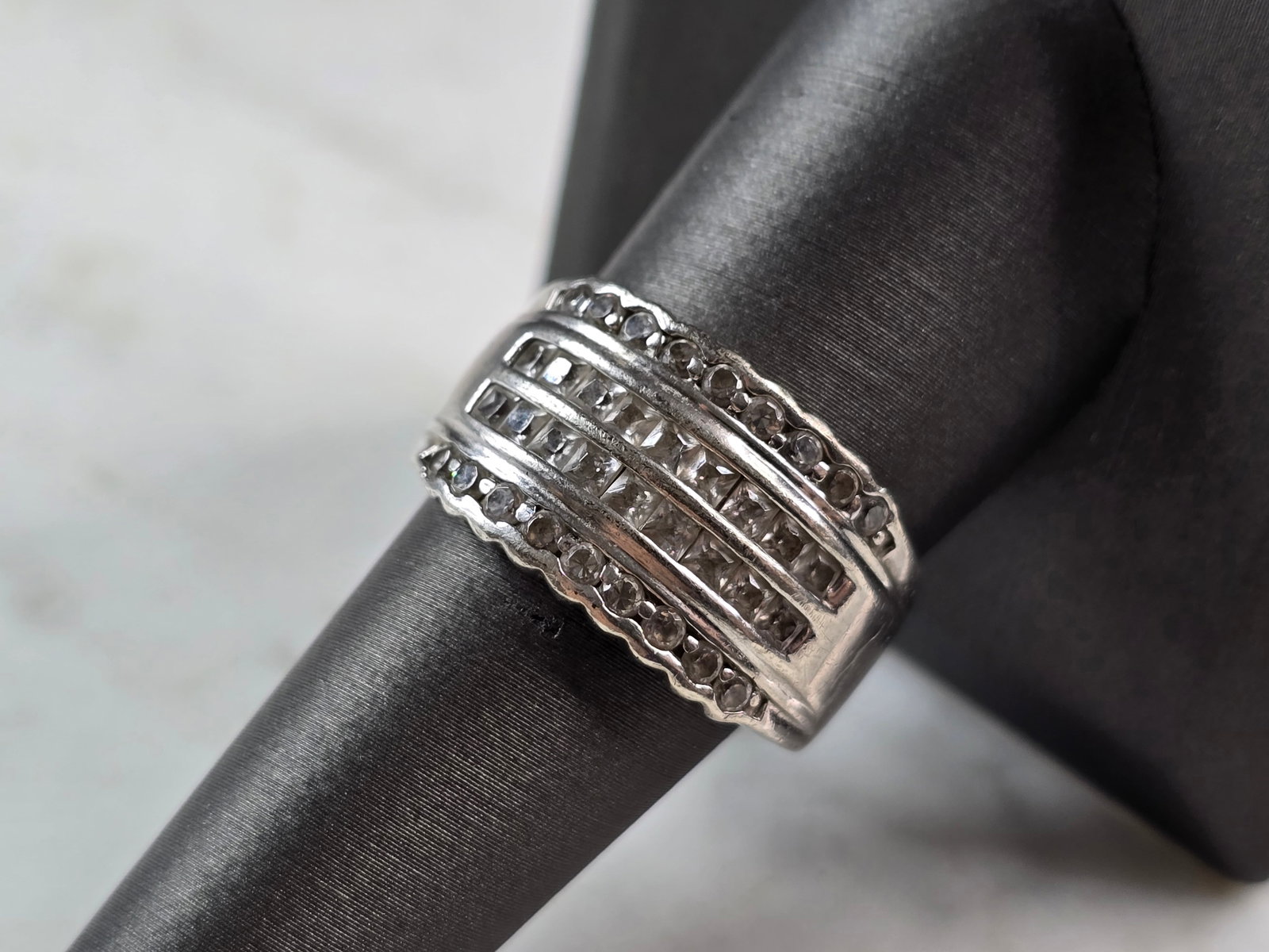 Womens Vintage Estate Sterling Silver CZ Ring: A WOMENS VINTAGE ESTATE STERLING SILVER RING WITH CZ STONES. THE RING SIZE IS A 9.0, AND WEIGHS 8.2g. THE WIDTH OF THE RING IS 1/2". THIS WOULD MAKE A NICE GIFT FOR THAT SOMEONE SPECIAL. ANY QUESTIONS