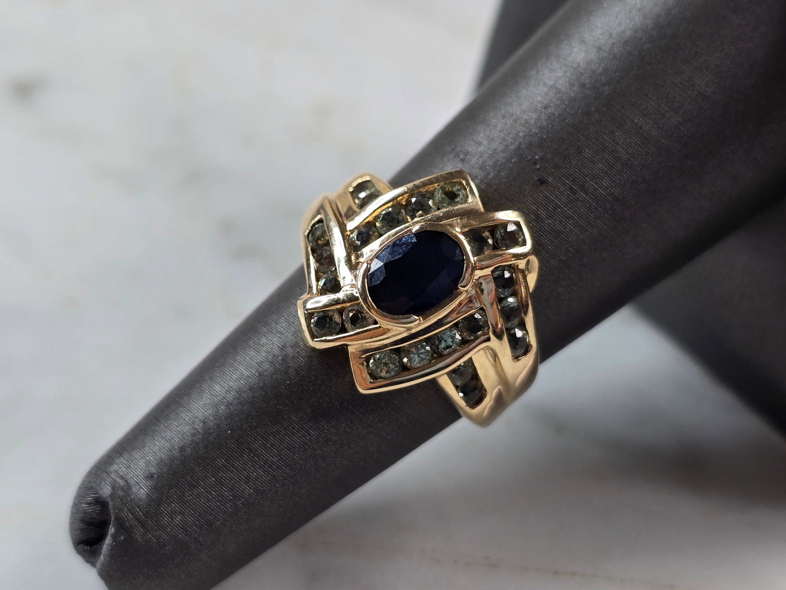Womens Vintage Estate 10K Gold Sapphire & Topaz Ring: A WOMENS VINTAGE ESTATE 10K GOLD SAPPHIRE AND TOPAZ RING. THE RING IS A SIZE 6.25, AND WEIGHS 4.7g. THE LENGTH OF THE RING IS 5/8". DID TEST AS SAPPHIRE AND TOPAZ, HOWEVER NOT SURE IF THE STONES ARE N