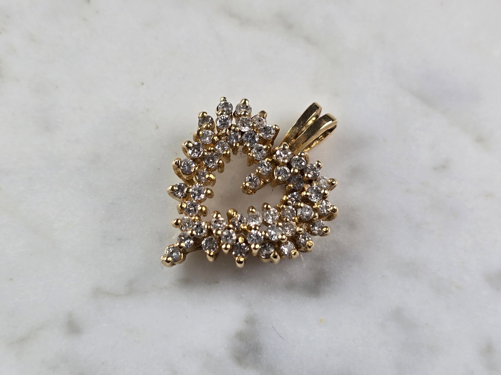 Womens Vintage Estate 14K Yellow Gold Heart Diamond Pendant: A WOMENS VINTAGE ESTATE 14K YELLOW GOLD HEART DIAMOND PENDANT. THE TOTAL WEIGHT IS 4.1g. THE PENDANT MEASURES 1" LONG BY 3/4" WIDE. THERE ARE ABOUT 40 TINY DIAMONDS IN THE PENDANT. PENDANT IS NOT MARK