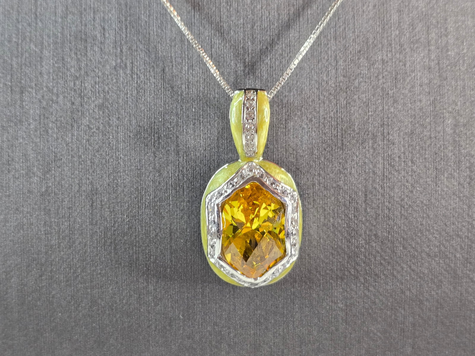 Womens Sterling Silver Necklace w/ Citrine Stone Enamel Pendant: A WOMENS VINTAGE ESTATE STERLING SILVER NECKLACE WITH A CITRINE COLORED AND ENAMEL PENDANT. NOT SURE IF THE STONE IS NATURAL OR MAN MADE. THE PENDANT MEASURES 1 1/4" BY 5/8". THE NECKLACE MEASURES 18"