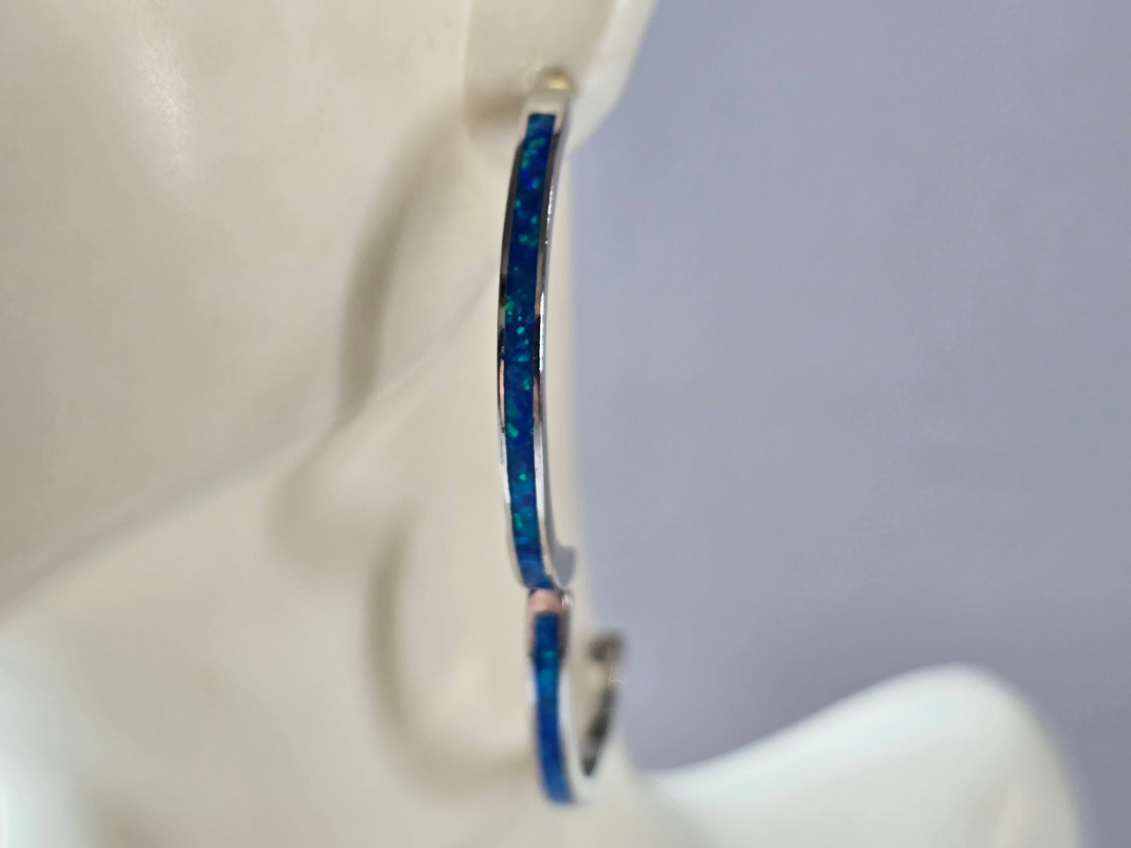 Womens Sterling Silver Modernist Blue Opal Hoop Earrings: A PAIR OF WOMENS STERLING SILVER BLUE OPAL COLORED EARRINGS THAT WEIGH 9.1g, AND MEASURES 1 1/4" BY 1/8" WIDE. NOT SURE IF STONES ARE NATURAL OR MAN MADE. ANY QUESTIONS, PLEASE DO NOT HESITATE TO ASK.