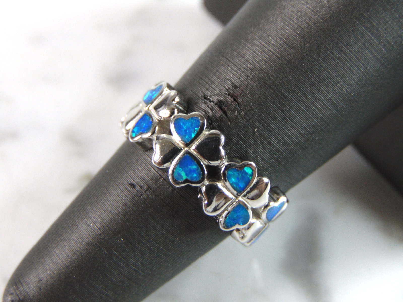 Womens Estate Sterling Silver Modernist Blue Opal Ring: A WOMENS ESTATE STERLING SILVER MODERNIST OPAL COLORED RING. THE RING IS A SIZE 7.0, AND WEIGHS 4.6g. NOT SURE IF STONE IS NATURAL OR MAN MADE. THE RING MAKES A BEAUTIFUL GIFT FOR THAT SOMEONE SPECIAL