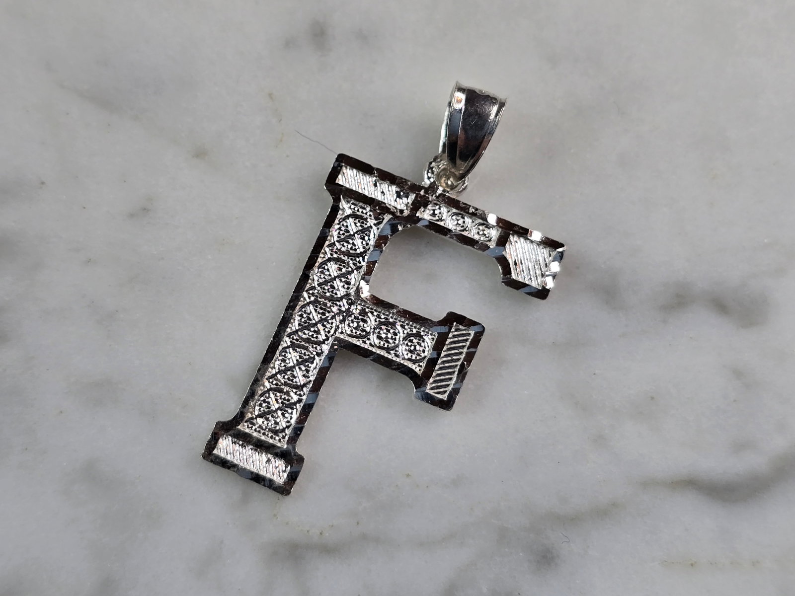 Womens Sterling Silver Initial Letter " F " Pendant: A WOMENS STERLING SILVER INITIAL LETTER "F" PENDANT. PENDANT WEIGHS 1.3g AND MEASURES 1 1/8" LONG BY 5/8" WIDE. MAKES A GREAT GIFT FOR THAT SOMEONE SPECIAL. ANY QUESTIONS, PLEASE ASK. BE SURE TO CHECK
