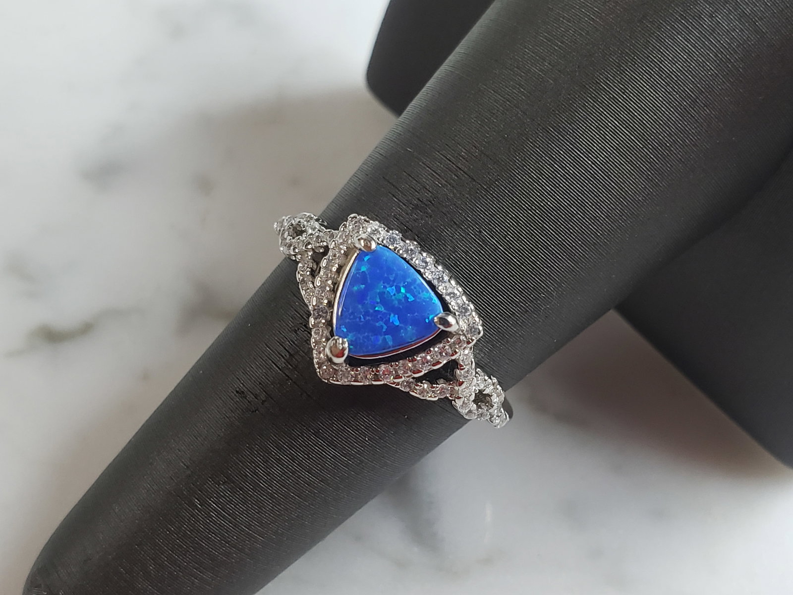 Womens Estate Sterling Silver Modernist Blue Opal Ring: A WOMENS ESTATE STERLING SILVER MODERNIST OPAL COLORED RING. THE RING IS A SIZE 7.5 AND WEIGHS 2.9g. WIDTH OF RING MEASURES 3/8". NOT SURE IF STONE IS NATURAL OR MAN MADE. THE RING MAKES A BEAUTIFUL G