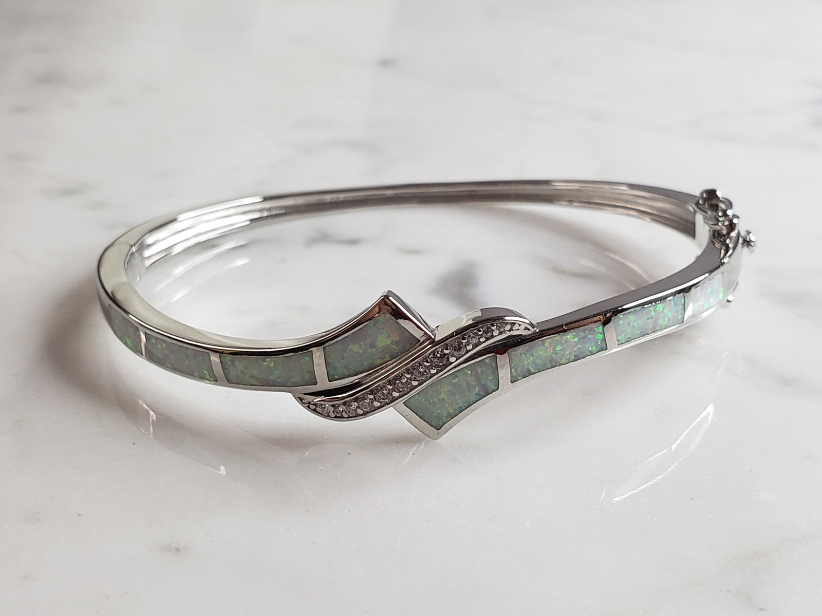 Womens Estate Sterling Silver Modernist Opal Bangle Bracelet: FOR SALE IS THIS WONDERFUL WOMENS STERLING SILVER MODERNIST OPAL COLORED BANGLE BRACELET. THE BRACELET WEIGHS 17.1g AND IS ABOUT 1/2" WIDE. THE CIRCUMFERENCE WITH THE GAP IS 6 3/4". NOT SURE IF STONE 