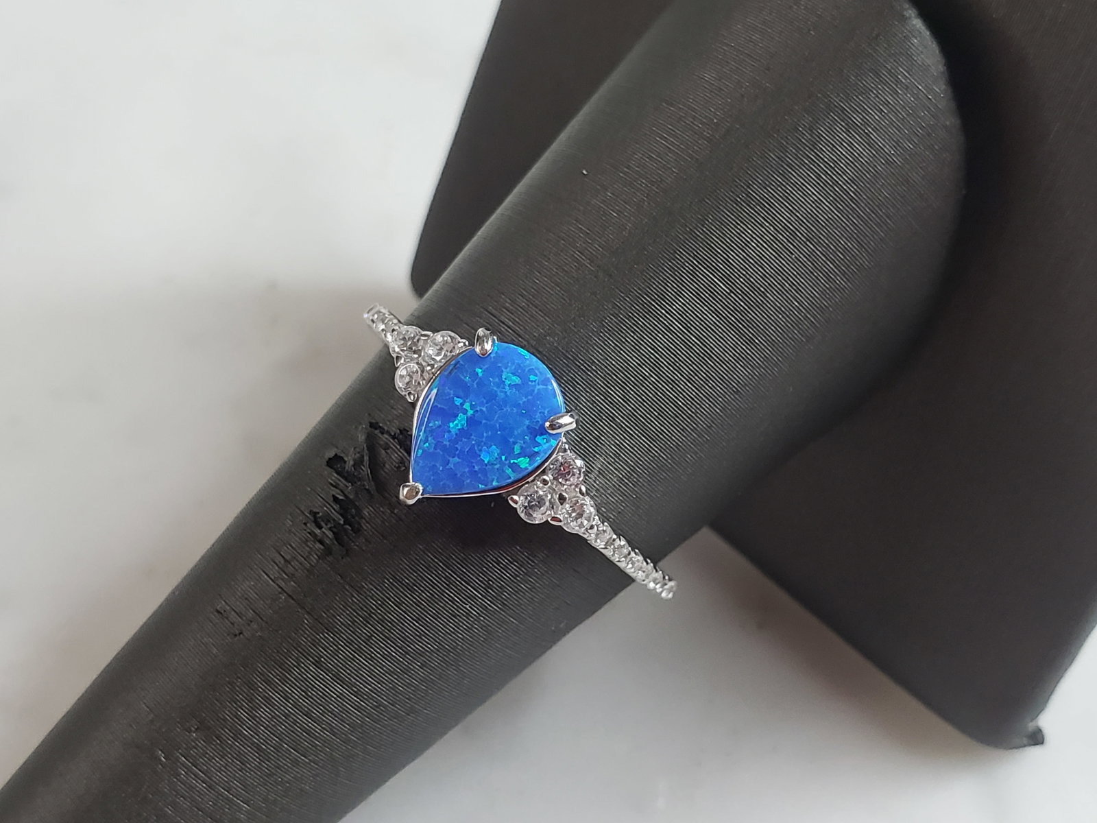 Womens Estate Sterling Silver Modernist Blue Opal Ring: A WOMENS ESTATE STERLING SILVER MODERNIST BLUE OPAL COLORED RING. THE RING IS A SIZE 8.25 AND WEIGHS 2.0g. WIDTH OF RING MEASURES 3/8". NOT SURE IF STONE IS NATURAL OR MAN MADE. THE RING MAKES A BEAUT