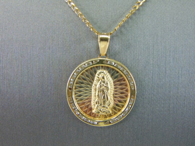 14K Mixed Gold Necklace W/ Religious Pendant: A 14K MIXED GOLD NECKLACE AND RELIGIOUS PENDANT. THE TOTAL WEIGHT IS 7.3g. THE NECKLACE MEASURES ABOUT 18" LONG BY 1/8" WIDE. THE PENDANT MEASURES 1 1/4" LONG BY 1" WIDE. STONES ARE CZ AND BOTH ARE MA
