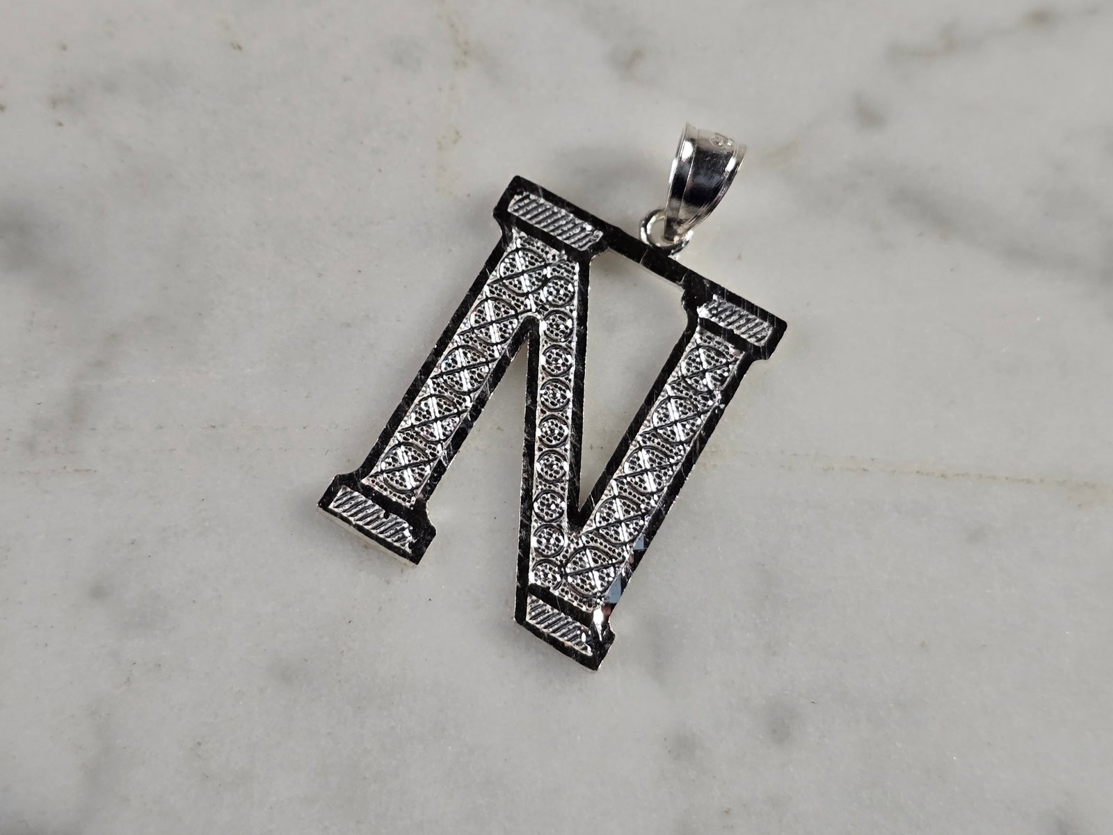 Womens Sterling Silver Initial Letter " N " Pendant: A WOMENS STERLING SILVER INITIAL LETTER "N" PENDANT. PENDANT WEIGHS 1.7g AND MEASURES 1 1/8" LONG BY 3/4" WIDE. MAKES A GREAT GIFT FOR THAT SOMEONE SPECIAL. ANY QUESTIONS, PLEASE ASK. BE SURE TO CHECK