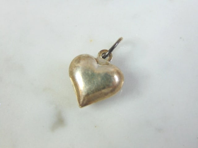 Womens Vintage Estate Sterling Silver Heart Charm: FOR SALE IS A VINTAGE ESTATE WOMEN'S STERLING SILVER HEART CHARM . CHARM MEASURES 3/4" LONG BY 1/2" WIDE AND WEIGHS 1.1g. MAKES A GREAT GIFT FOR THAT SOMEONE SPECIAL. IF ANY QUESTIONS, PLEASE ASK. BE 