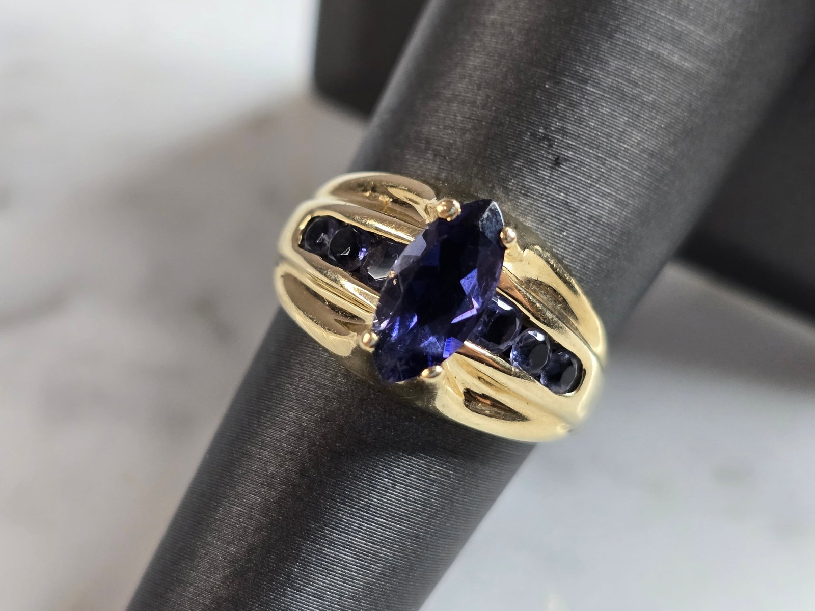 Womens Vintage Estate 14K Yellow Gold Tanzanite Ring: A WOMENS VINTAGE ESTATE 14K YELLOW GOLD TANZANITE RING. RING IS A SIZE 6.5 AND WEIGHS 4.8g. THE CENTER STONE IS ABOUT 1.0cts. THE WIDTH OF THR RING IS ABOUT 1/2". NOT SURE IF STONES ARE NATURAL OR MAN
