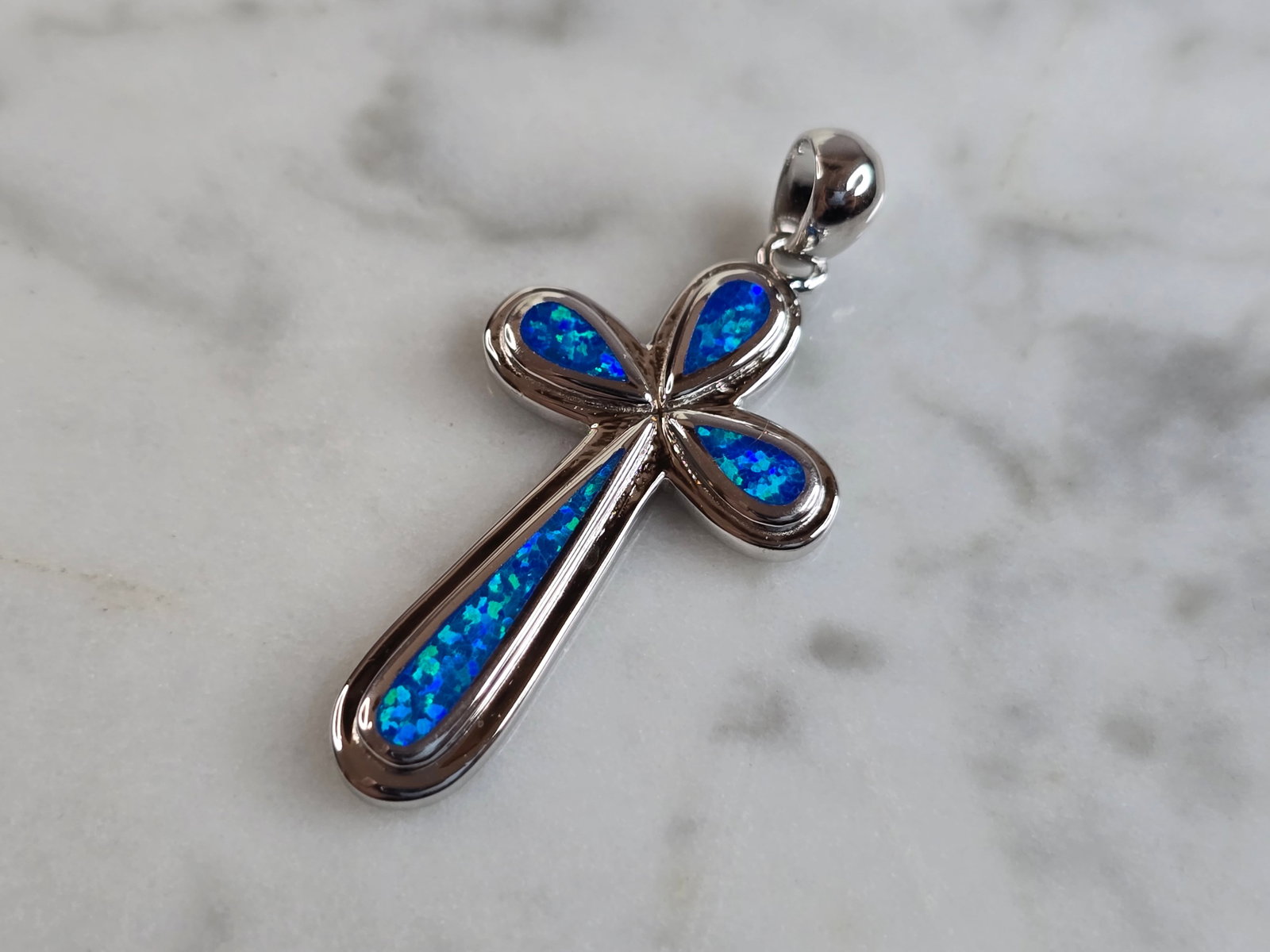 Womens Sterling Silver Blue Opal Religious Cross Pendant: A WOMENS ESTATE STERLING SILVER BLUE OPAL RELIGIOUS CROSS PENDANT. NOT SURE IF STONES ARE REAL OR MAN MADE. THE PENDANT WEIGHS 4.1g, AND MEASURES 1 3/8" LONG BY 5/8" WIDE. MAKES A GREAT GIFT FOR THAT 