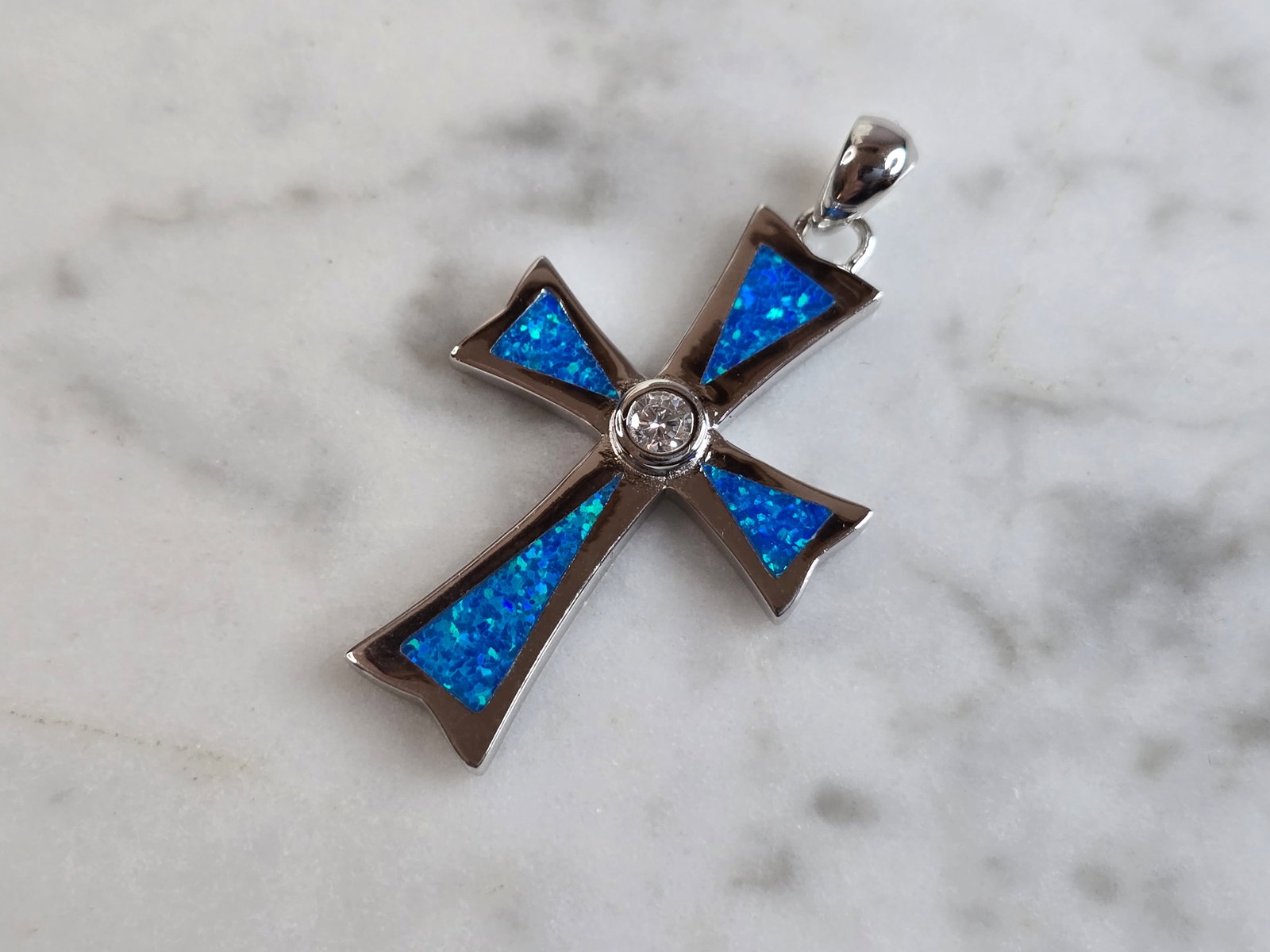 Womens Sterling Silver Blue Opal Religious Cross Pendant: A WOMENS ESTATE STERLING SILVER BLUE OPAL RELIGIOUS CROSS PENDANT. NOT SURE IF STONES ARE REAL OR MAN MADE. THE PENDANT WEIGHS 4.2g, AND MEASURES 1 3/8" LONG BY 3/4" WIDE. MAKES A GREAT GIFT FOR THAT 