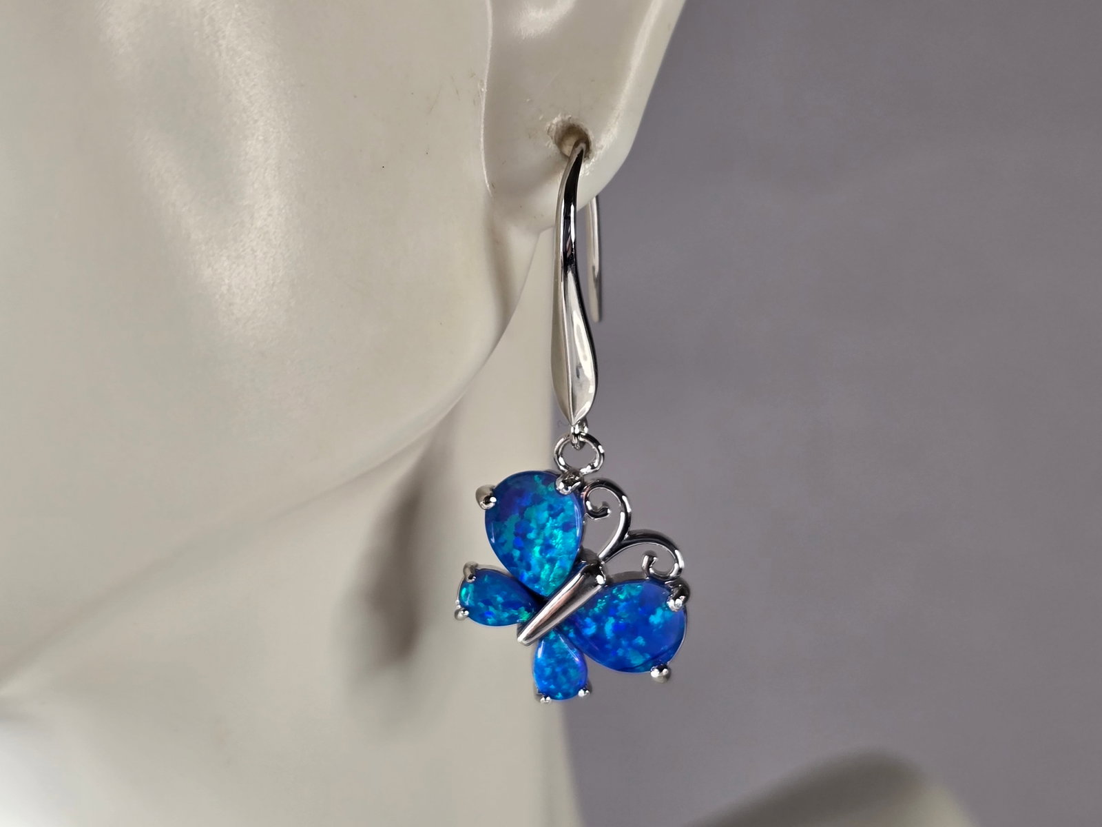 Womens Estate Sterling Silver Blue Opal Butterfly Earrings: A PAIR OF WOMENS STERLING SILVER BLUE OPAL COLORED BUTTERFLY EARRINGS THAT WEIGH 5.5g AND MEASURES 1 1/2" LONG BY 5/8" WIDE. NOT SURE IF STONES ARE REAL OR MAN MADE. ANY QUESTIONS, PLEASE DO NOT HESIT