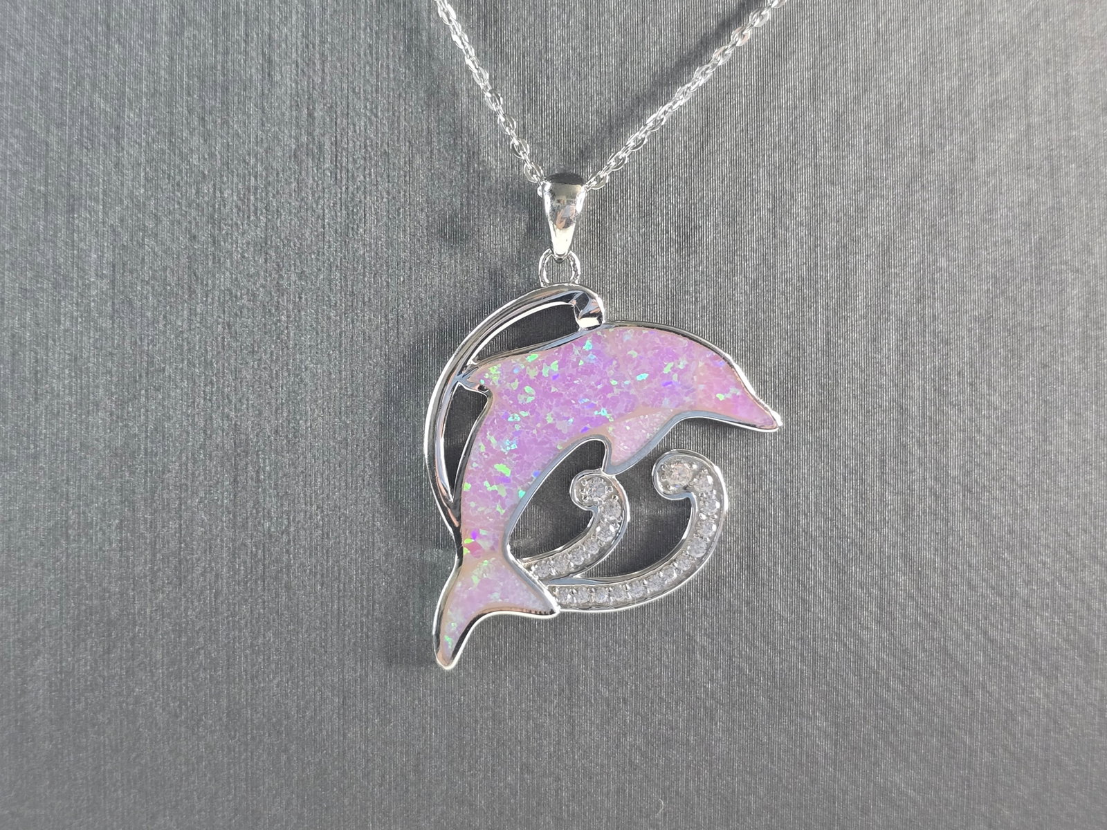 Womens Sterling Silver Pink Opal Dolphin Pendant Necklace: A WOMENS STERLING SILVER PINK OPAL DOLPHIN PENDANT WITH NECKLACE. THE PENDANT WITH NECKLACE WEIGHS 6.7g. PENDANT MEASURES 1 3/8" LONG BY 1" WIDE, AND THE NECKLACE MEASURES 18" LONG, ADJUSTABLE TO 16".