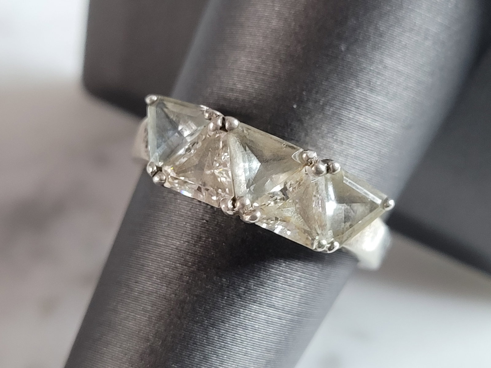 Womens Vintage Estate Sterling Silver Modernist CZ Ring: A WOMENS VINTAGE ESTATE STERLING SILVER MODERNIST CZ RING THAT WEIGHS 3.4g. THE RING IS A SIZE 8.75. THE WIDTH OF THE RING IS 1/4". RING IS MARKED ON THE INSIDE OF THE BAND. THIS WOULD MAKE A NICE GIF