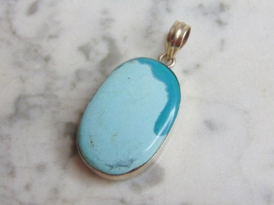 Womens Vintage Sterling Silver Turquoise Stone Pendant: A WOMENS VINTAGE ESTATE STERLING SILVER TURQUOISE STONE PENDANT . NOT SURE IF STONE IS REAL OR MAN MADE. PENDANT WEIGHS 16.2g AND PENDANT MEASURES 2 1/8" LONG BY 1" WIDE. MAKES A GREAT GIFT FOR THAT S