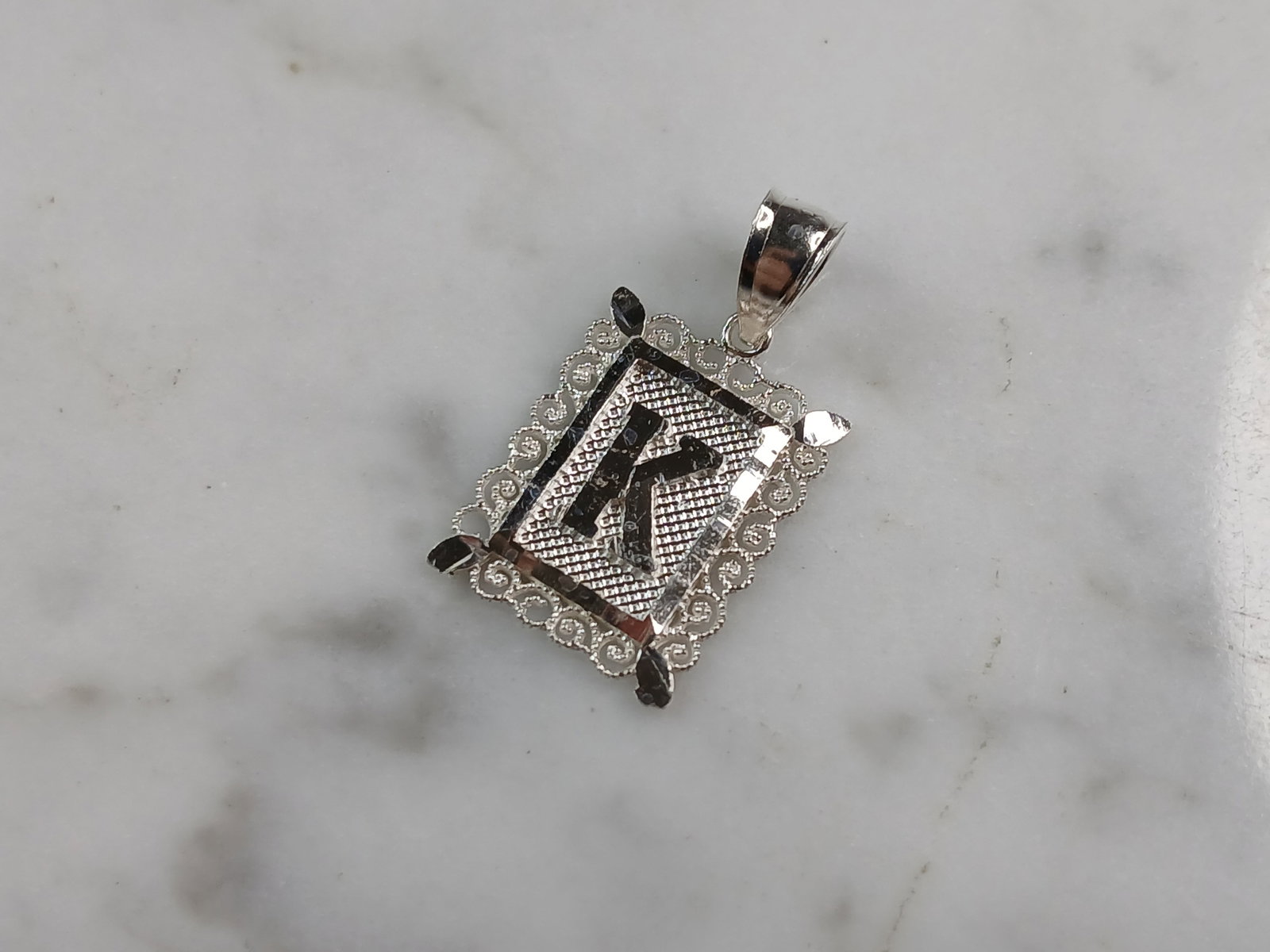 Womens Sterling Silver Initial Letter " K " Pendant: A WOMENS STERLING SILVER INITIAL LETTER "K" PENDANT. PENDANT WEIGHS 1.0g AND MEASURES 7/8" LONG BY 1/2" WIDE. MAKES A GREAT GIFT FOR THAT SOMEONE SPECIAL. ANY QUESTIONS, PLEASE ASK. BE SURE TO CHECK O