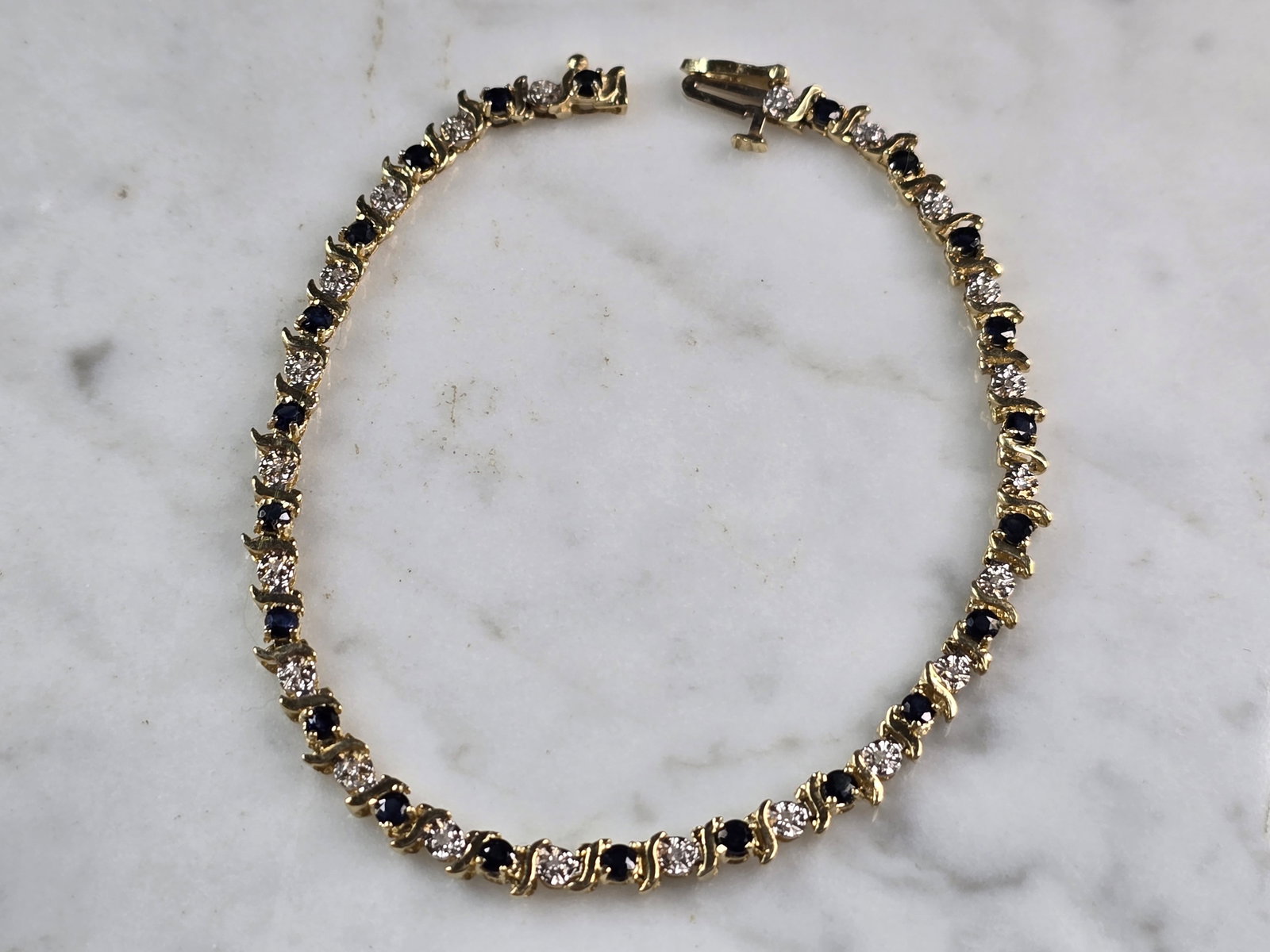 Womens Vintage Estate 14k Gold Diamond & Sapphire Tennis Bracelet: A WOMENS VINTAGE ESTATE 14K GOLD DIAMOND & SAPPHIRE TENNIS BRACELET. BRACELET IS 7 1/2" LONG BY 1/8" WIDE, AND WEIGHS 7.0g. THERE ARE 22 TINY DIAMONDS, AND 22 TINY SAPPHIRES. THIS WOULD MAKE A LOVELY 