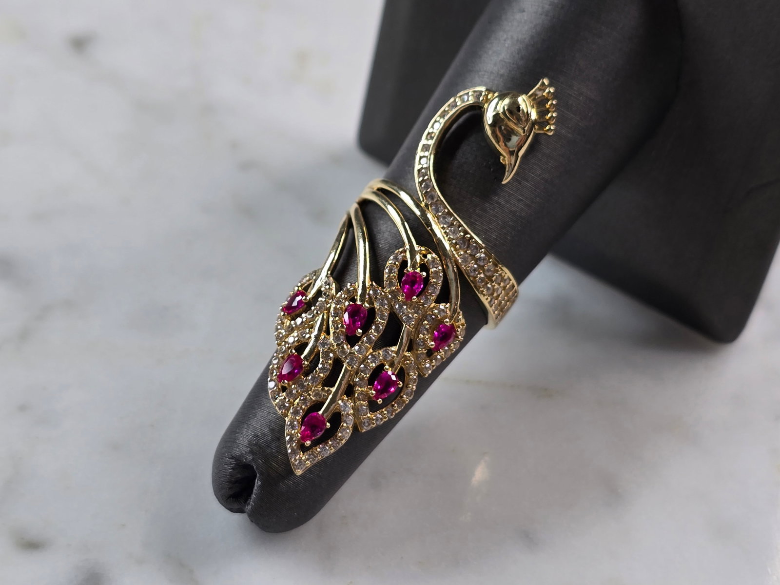 Womens 14k Yellow Gold Modernist Multi Stone Peacock Ring: A UNIQUE WOMENS 14K YELLOW GOLD MODERNIST PEACOCK RING WITH MULTI COLORED STONES. THE RING SIZE IS A 6.5, AND WEIGHS 6.1g. THE LENGTH OF THE RING IS 1 3/4". RING HAS A FAINT MARK ON THE INSIDE. STONES