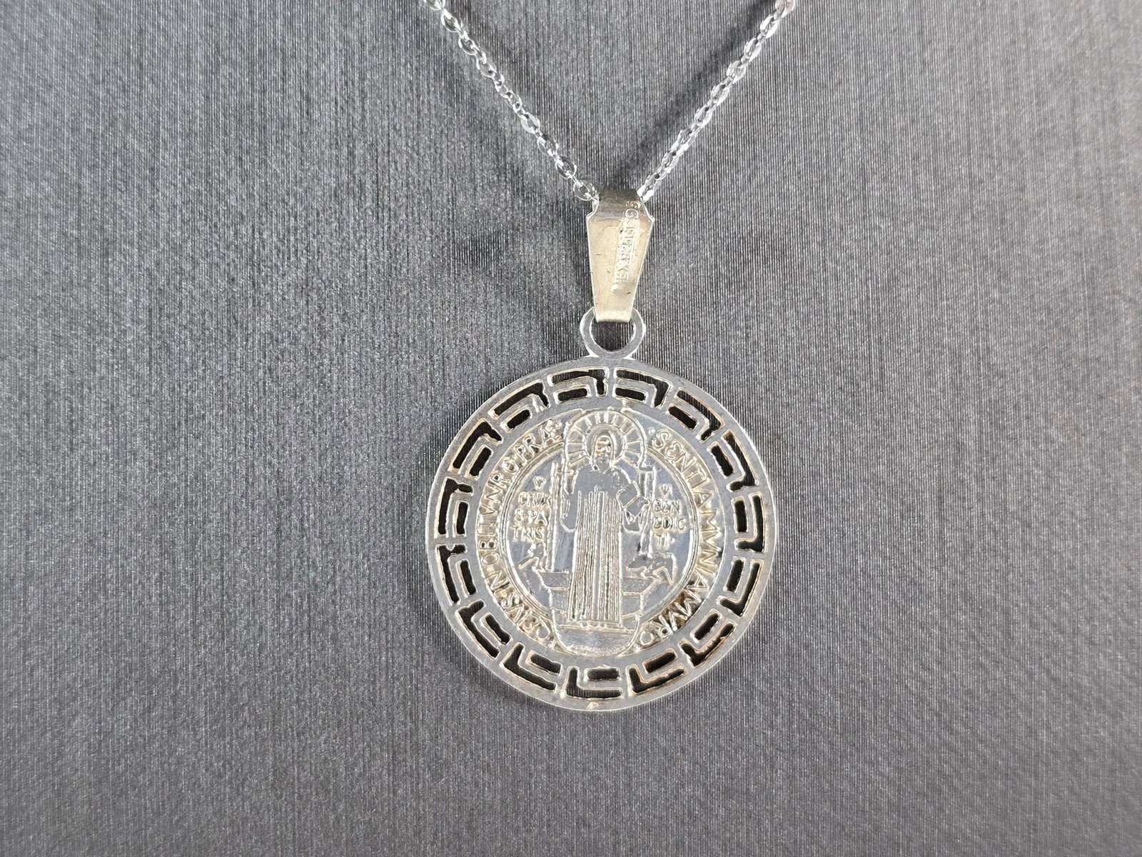 Sterling Silver Religious St Benedict Cross Pendant Necklace: A STERLING SILVER RELGIOUS ST. BENEDICT CROSS PENDANT WITH NECKLACE . THE TOTAL WEIGHT IS 5.0g. THE PENDANT MEASURES 1 1/2" LONG BY 1" WIDE. THE NECKLACE MEASURES 18" LONG AND IS ADJUSTABLE TO 16" LON