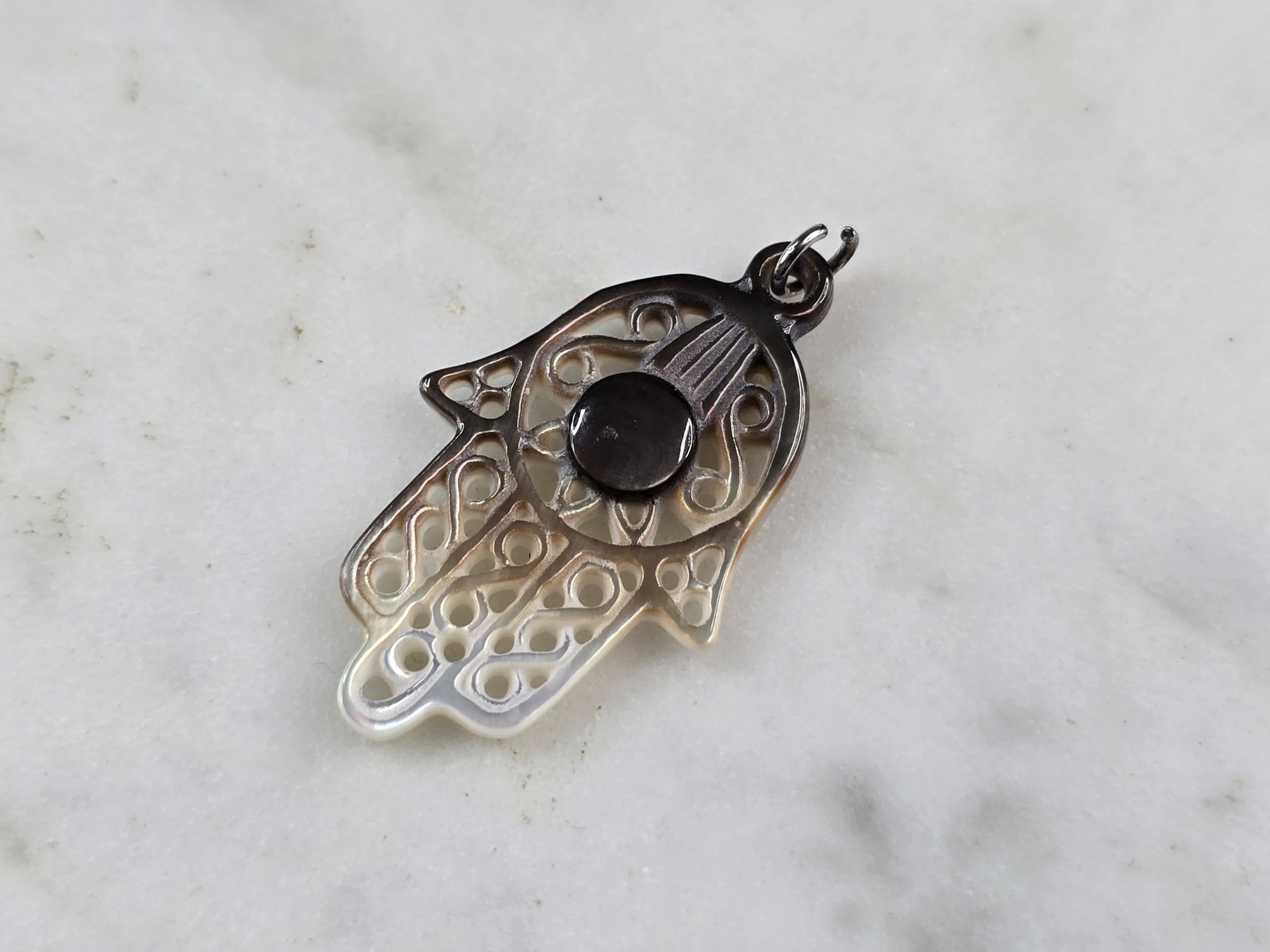 Womens Mother of Pearl ? Religious Hamsa Hand Pendant: A WOMENS RELIGIOUS HAMSA HAND PENDANT THAT APPEARS TO BE MADE OF MOTHER OF PEARL. THE PENDANT MEASURES 1 1/8" BY 5/8". NOT SURE IF THE PENDANT IS NATURAL MOP OR MAND MADE. STILL A VERY PRETTY AND UNUS